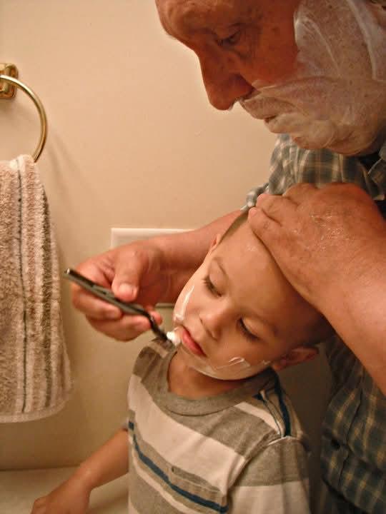 A man shaving a child's head