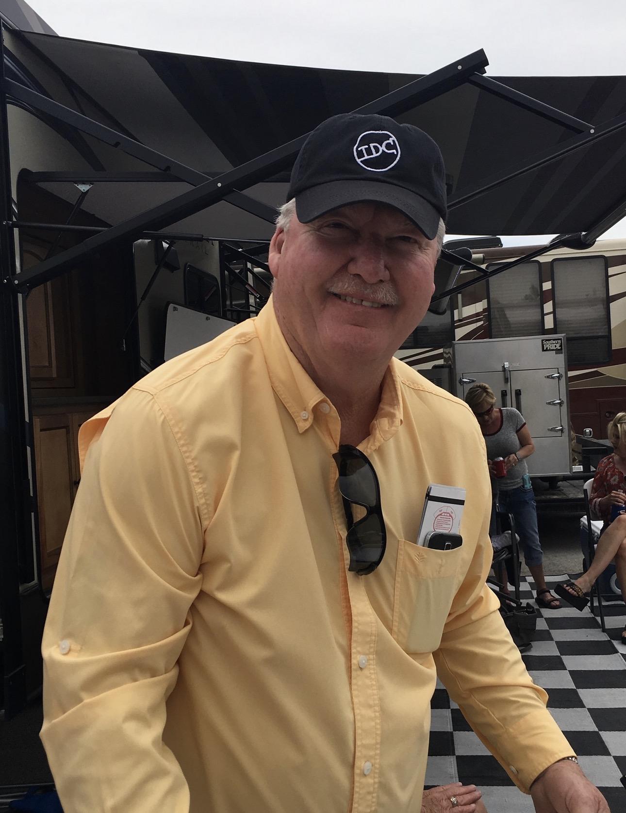 A man wearing a hat and sunglasses