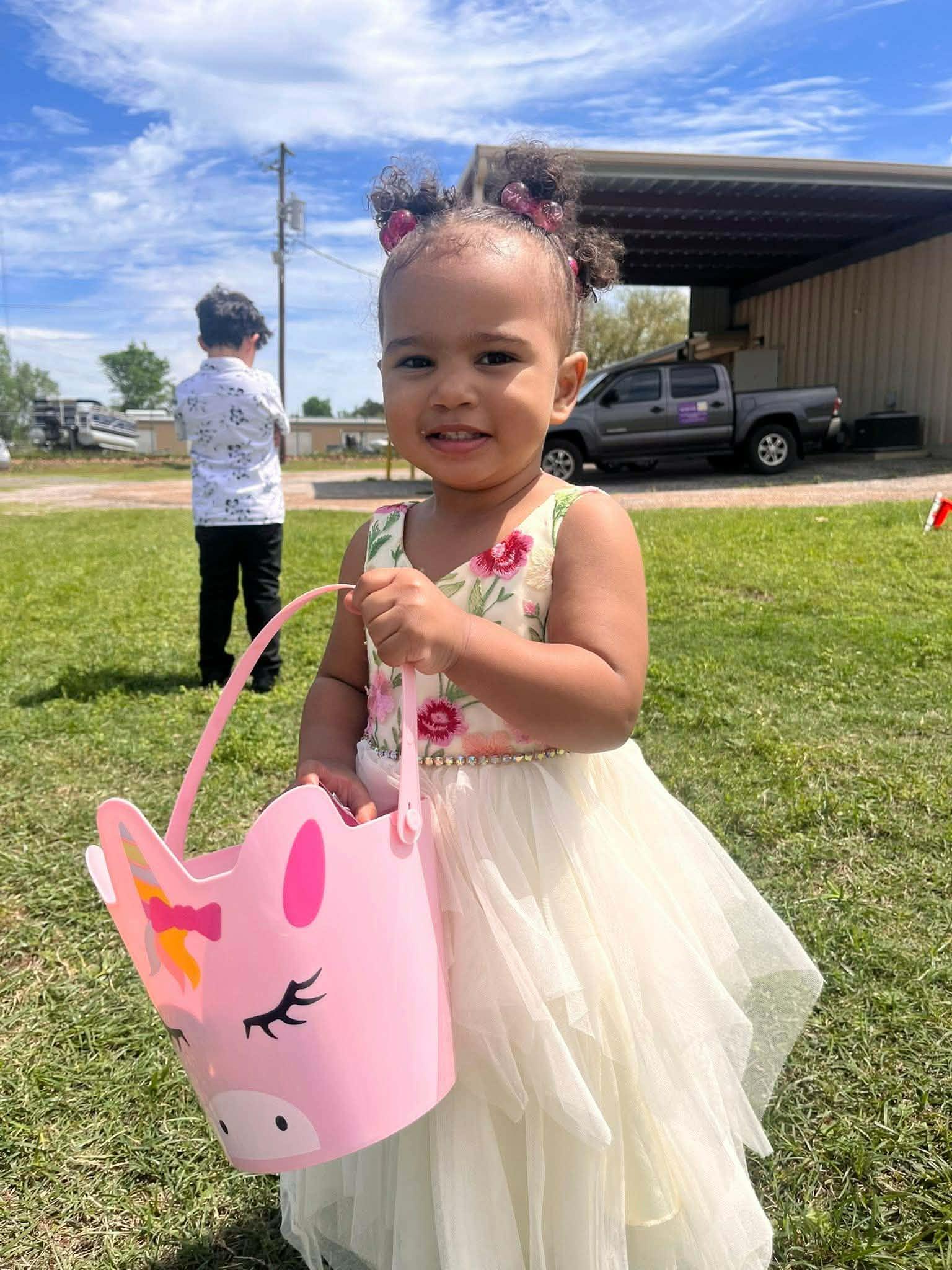 A girl holding a pink bag