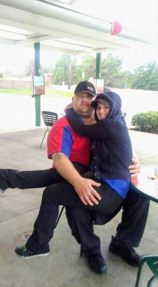 A man and woman sitting on a table