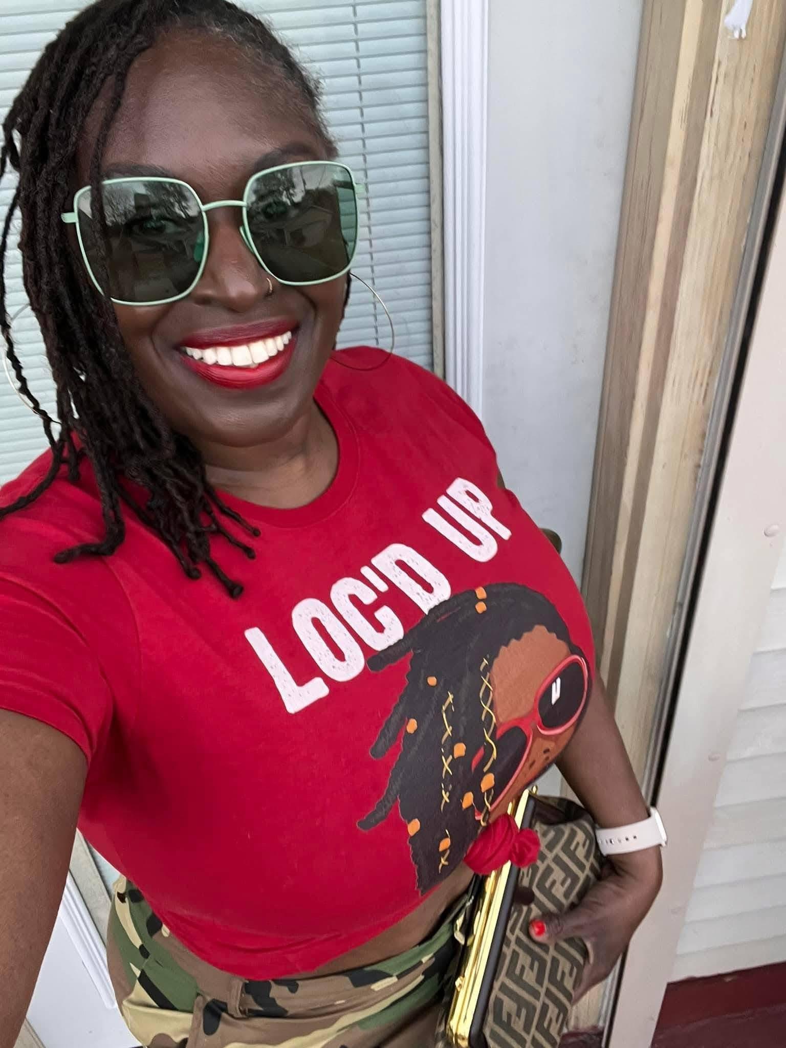 A woman wearing sunglasses and a red shirt