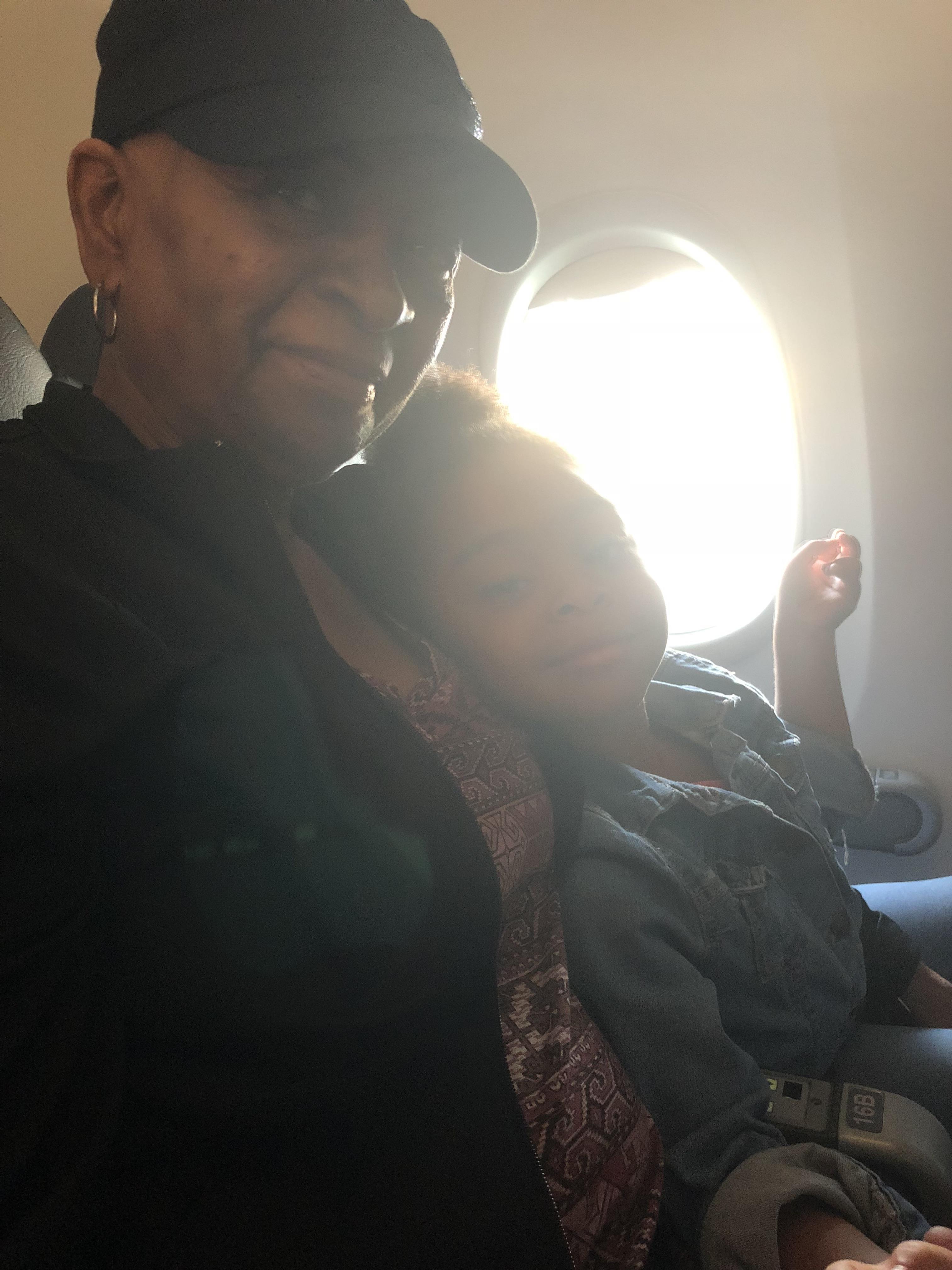A woman and child sitting on an airplane