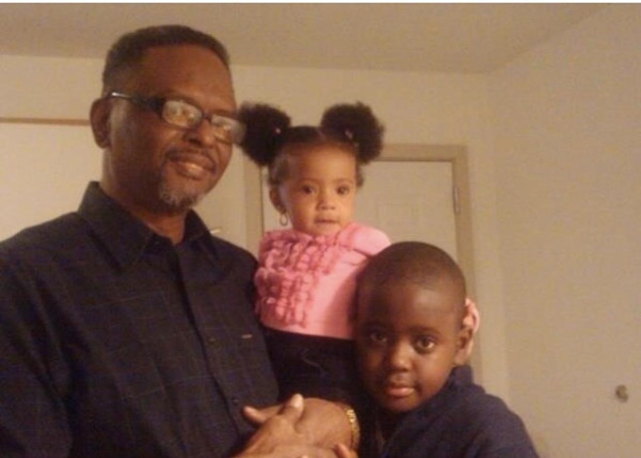 A man holding a child and a girl