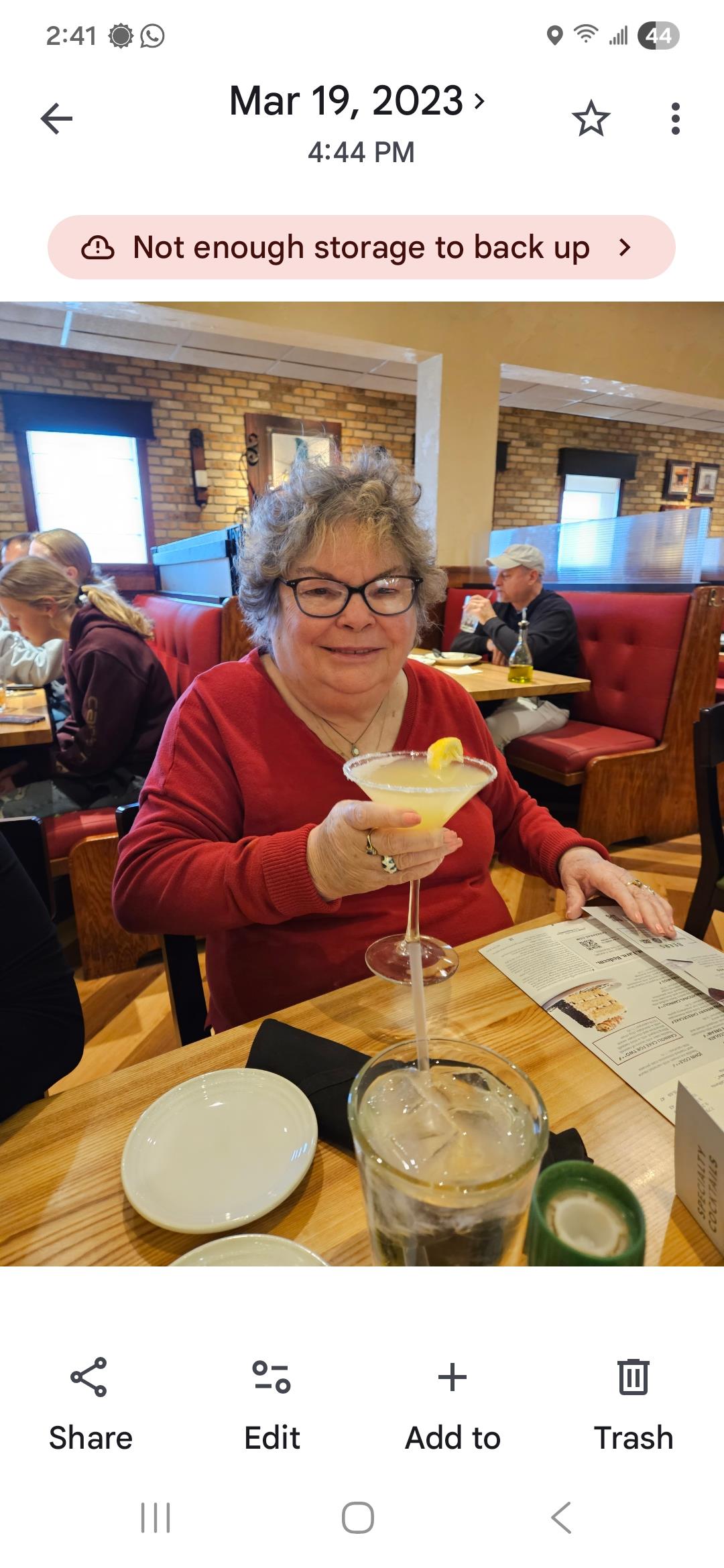 A woman sitting at a table with a martini glass