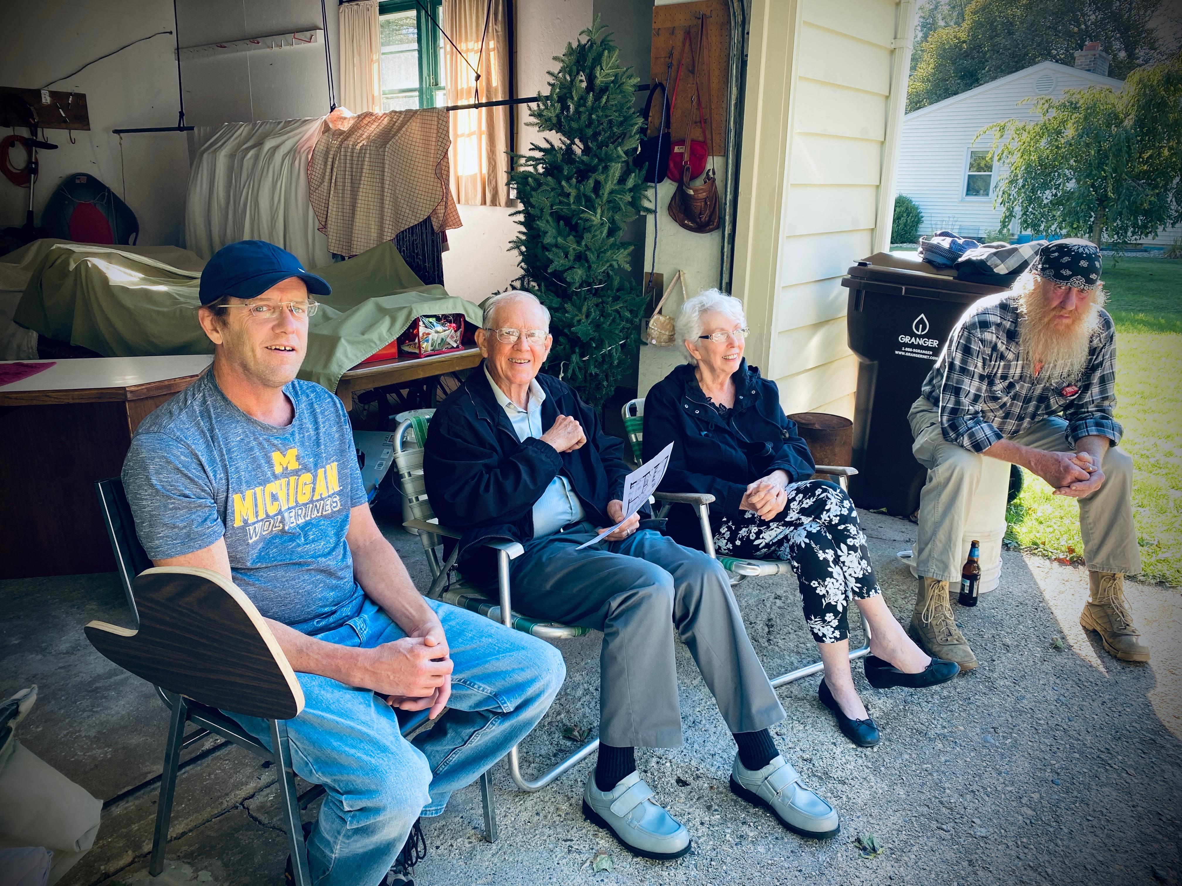A group of people sitting outside