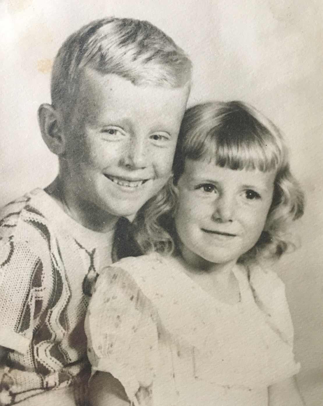 A boy and girl posing for a picture
