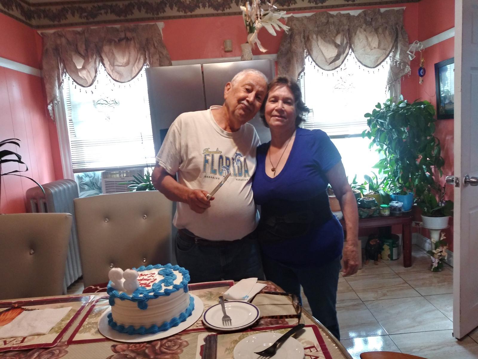 A man and woman standing in front of a cake