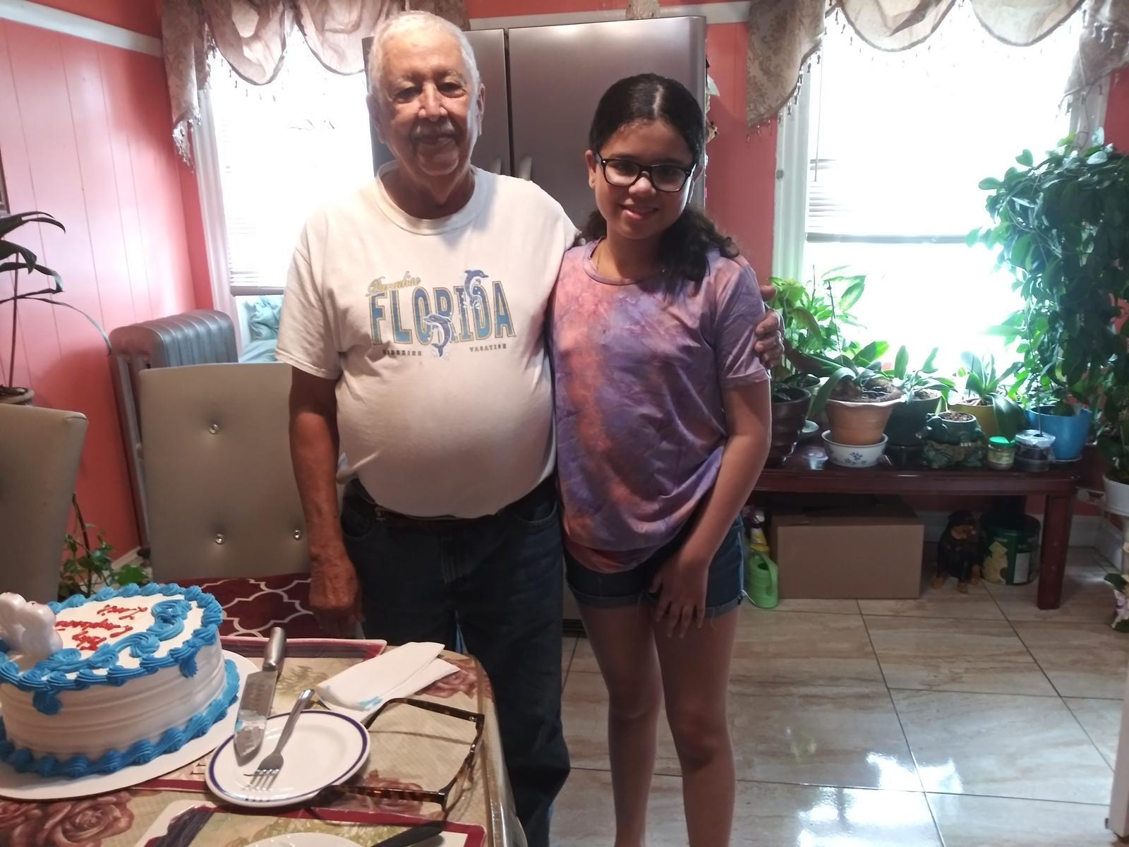 A man and a girl standing in a kitchen