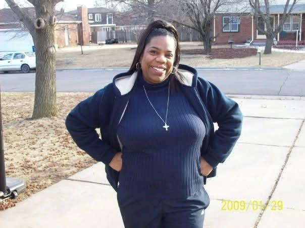 A woman standing on a sidewalk