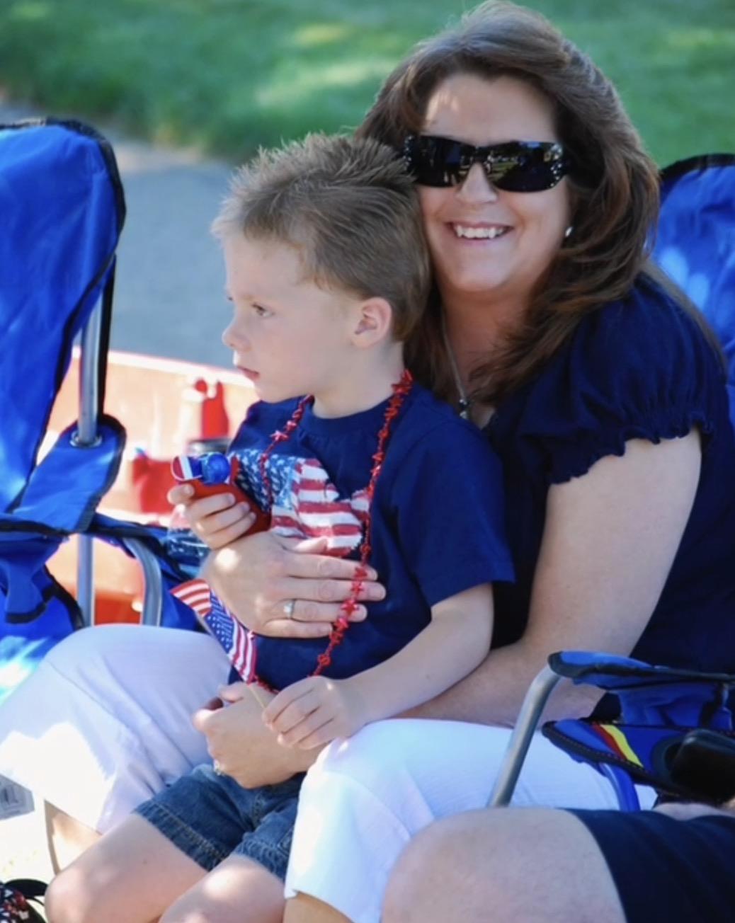 A woman and a boy sitting in a stroller