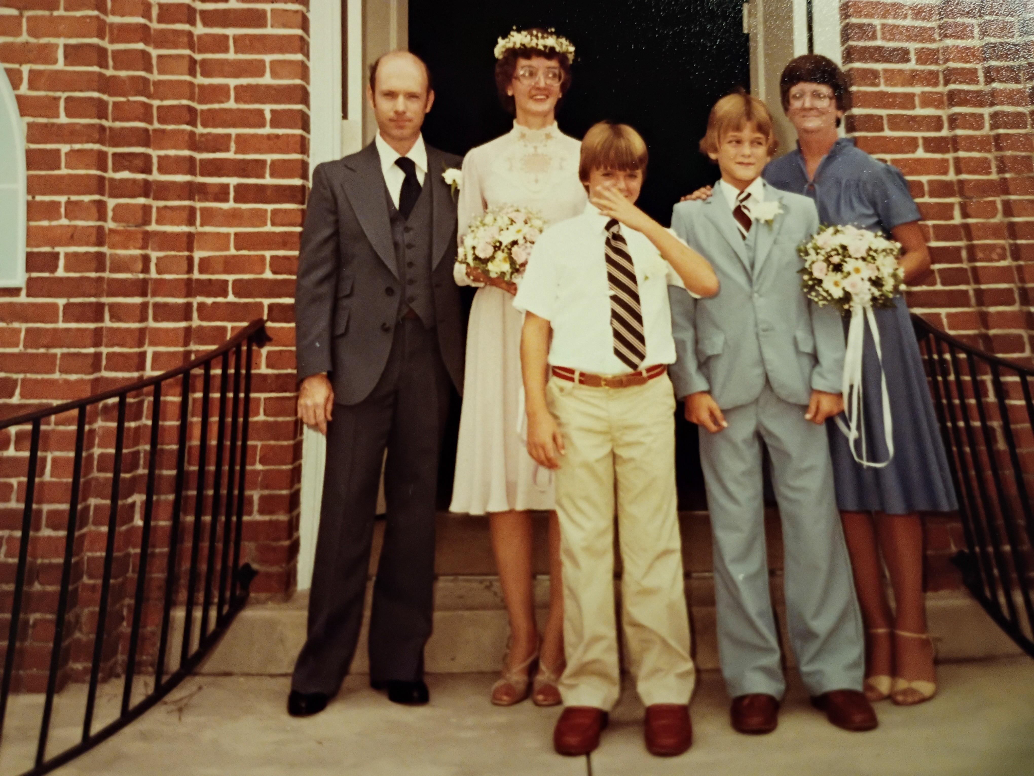 A group of people standing in front of a brick building