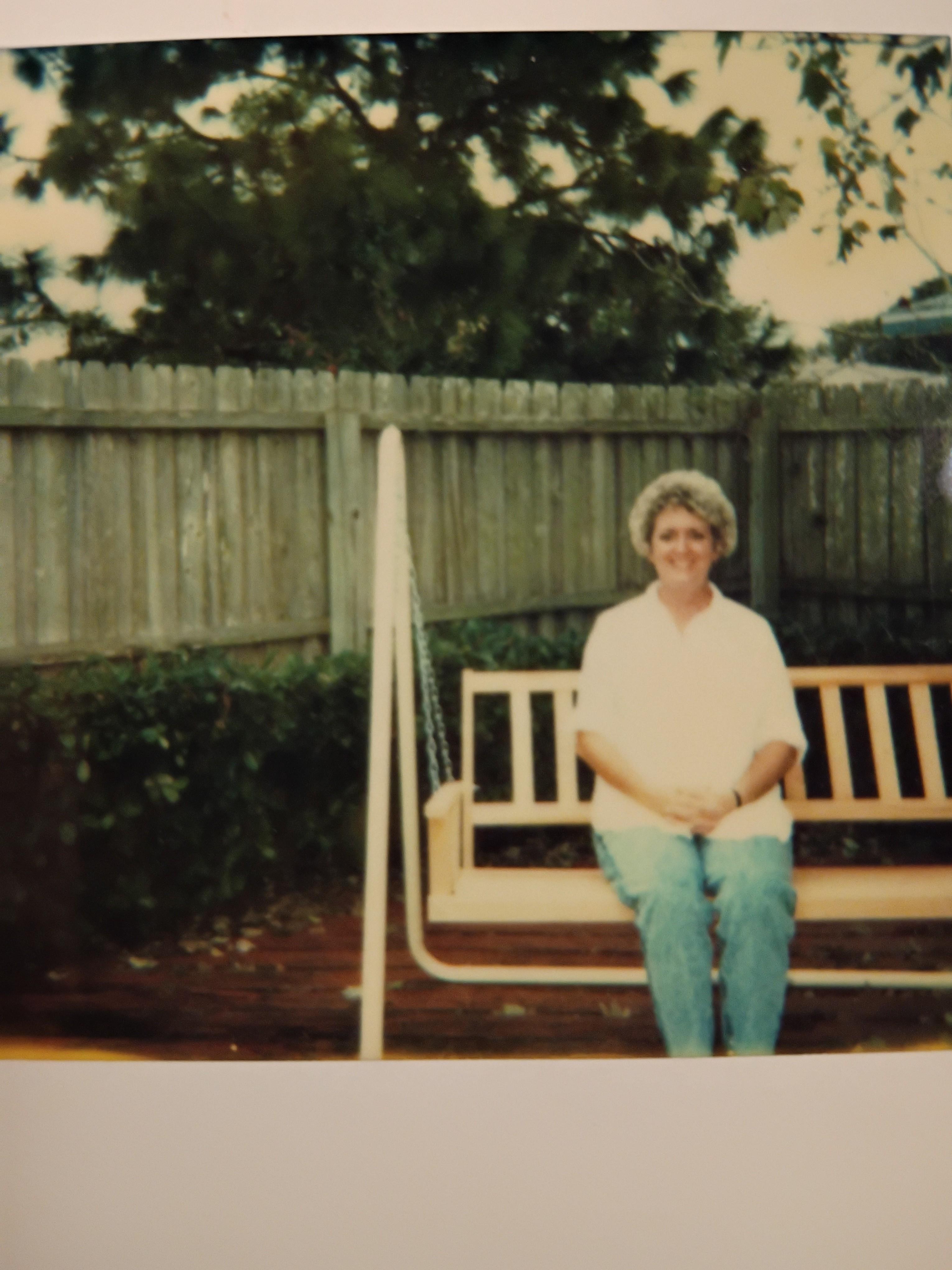 A woman sitting on a wooden swing