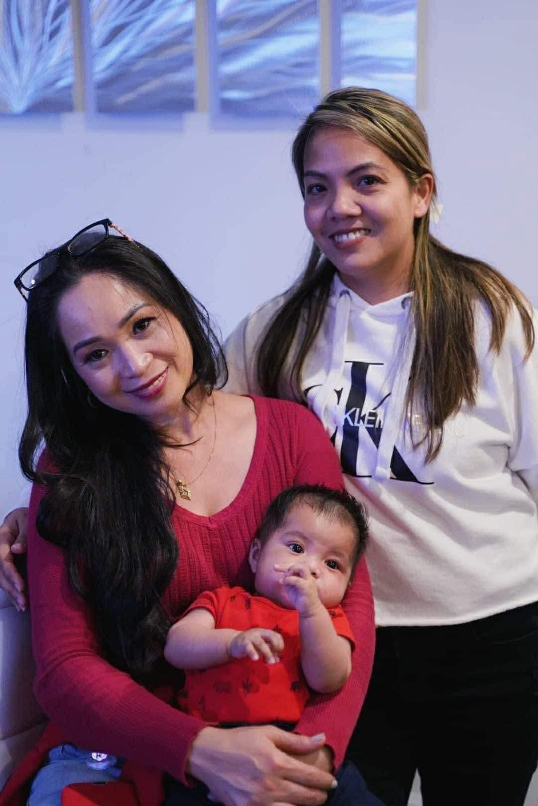 A group of women posing for a picture with a baby