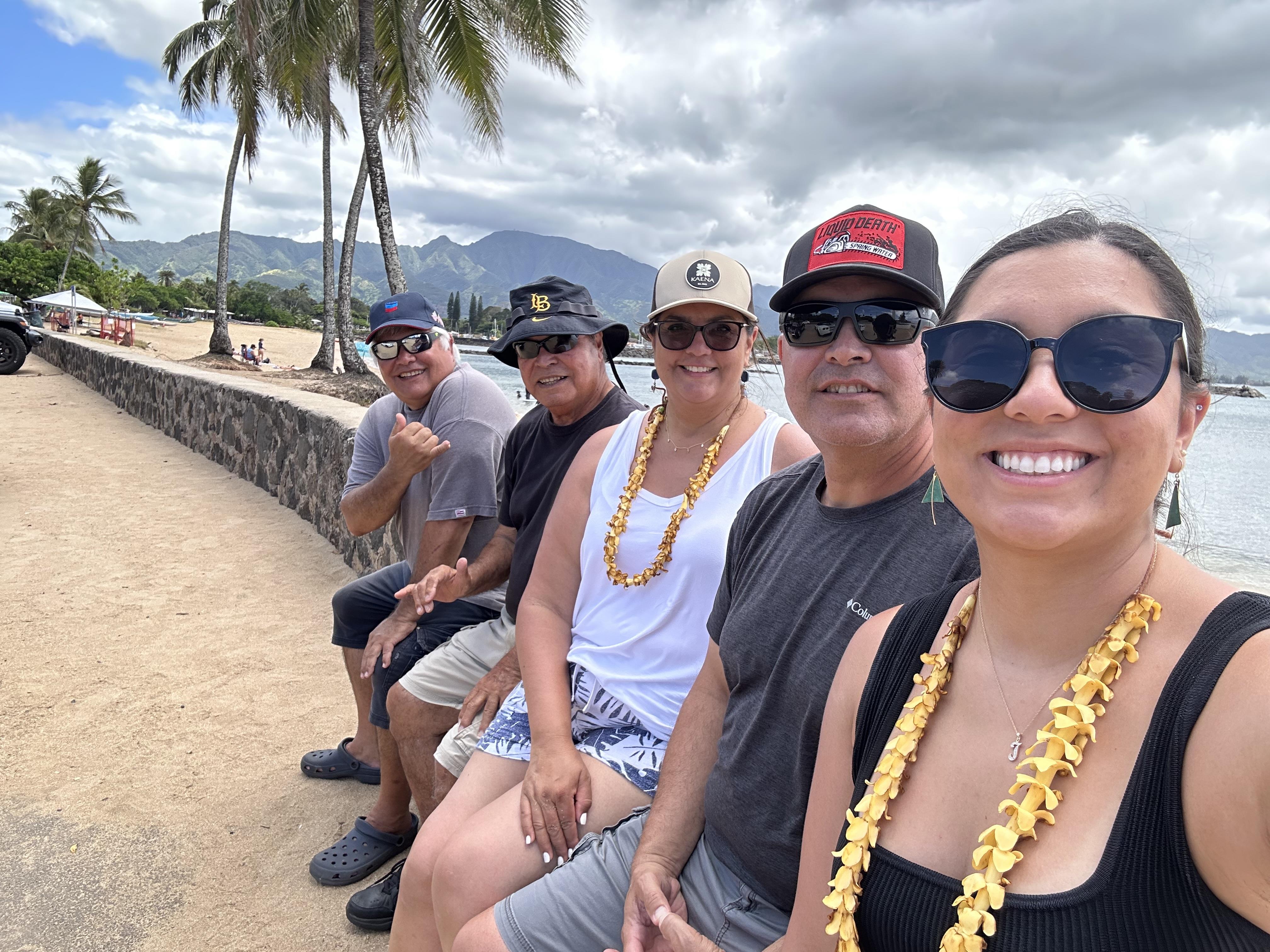 A group of people sitting on a wall