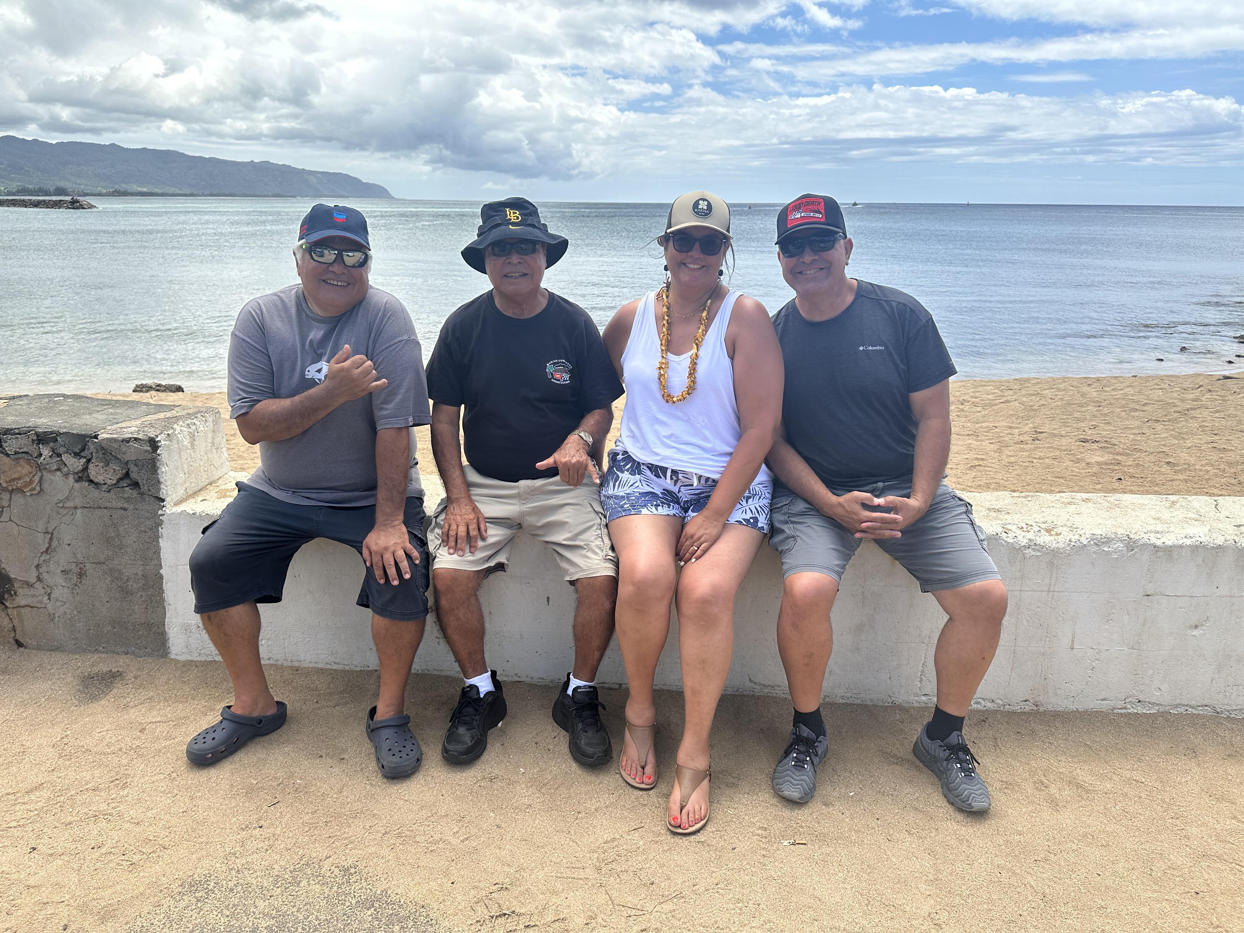 A group of people sitting on a wall