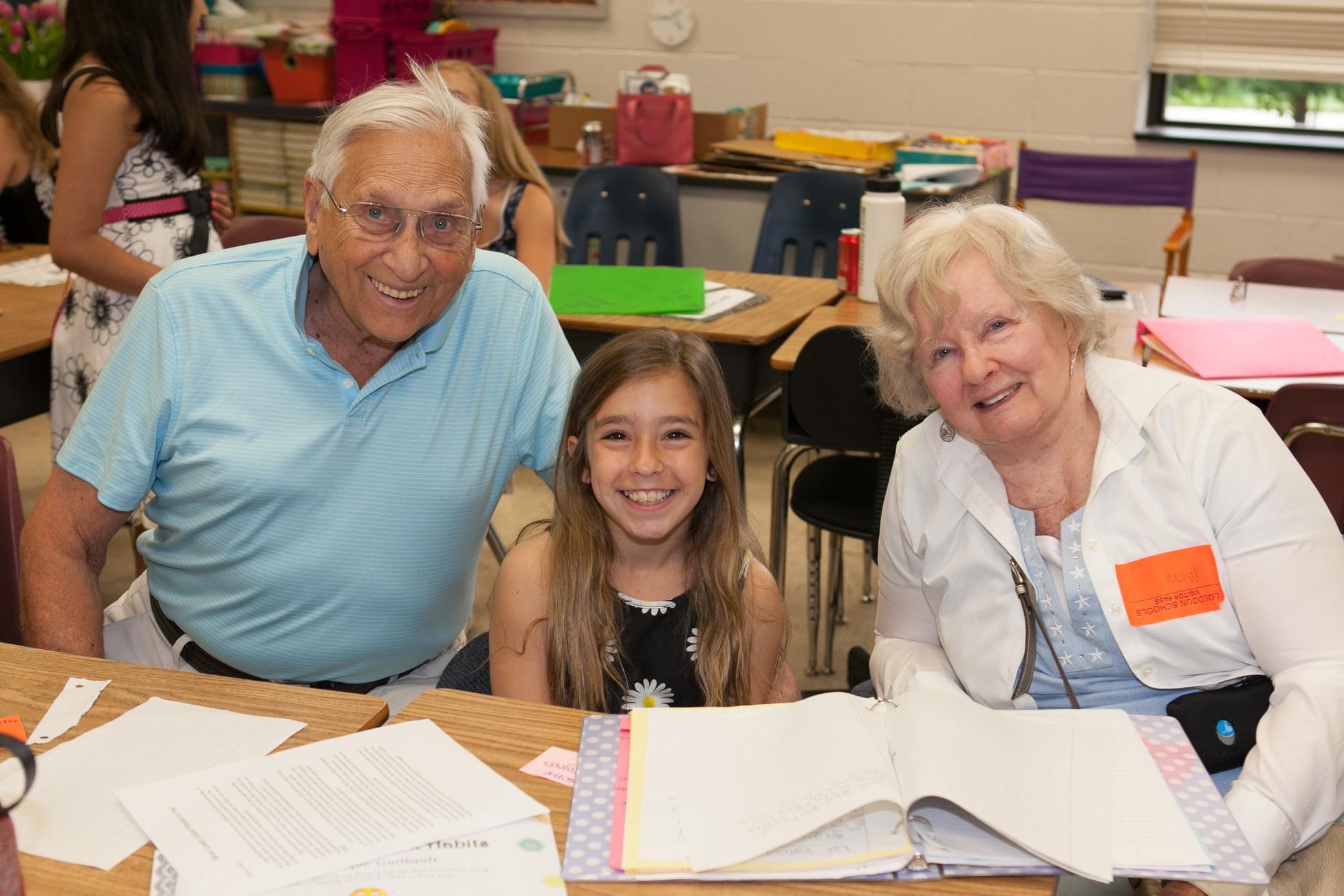 A group of people smiling at a table