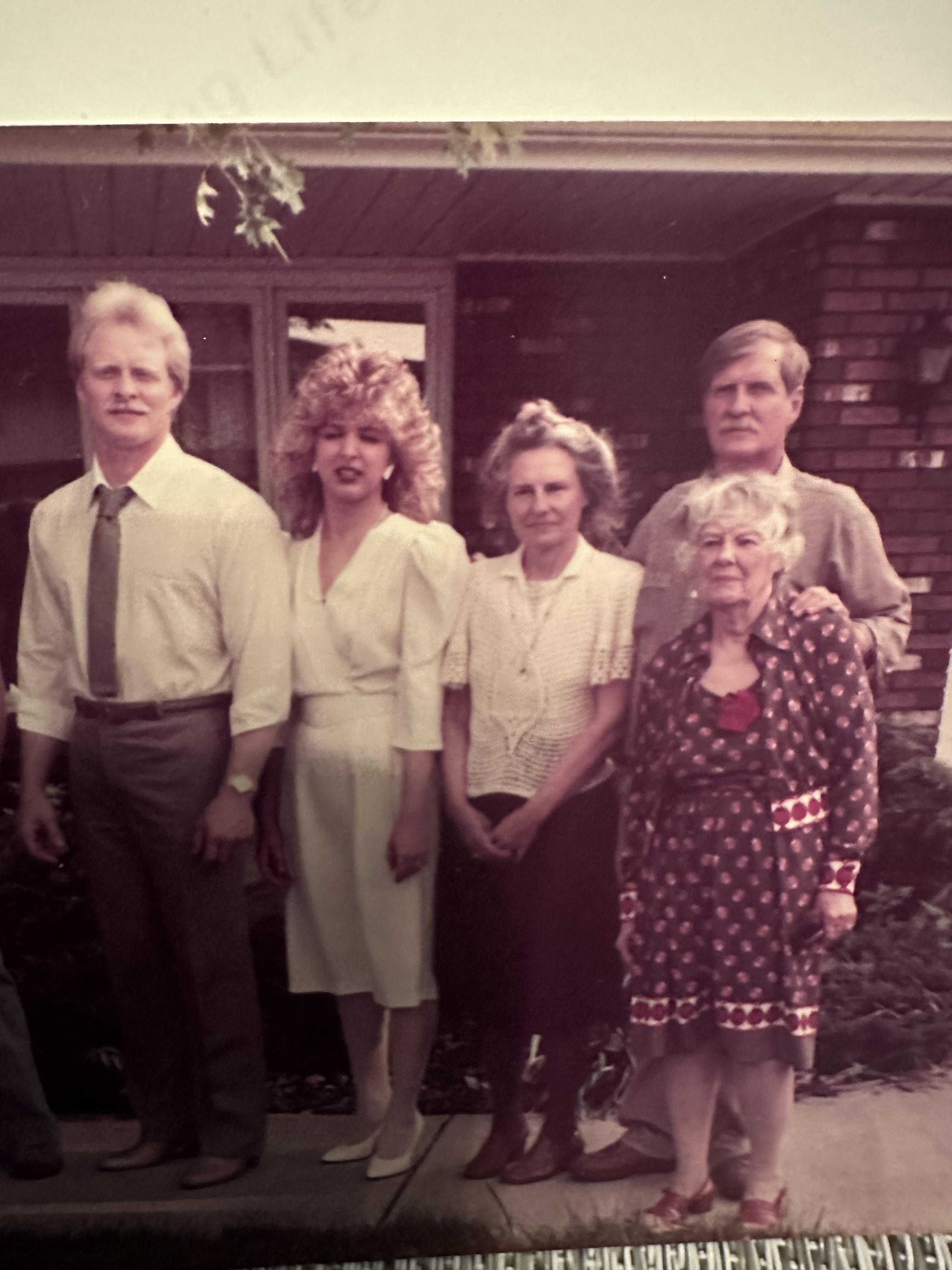 A group of people standing outside a house