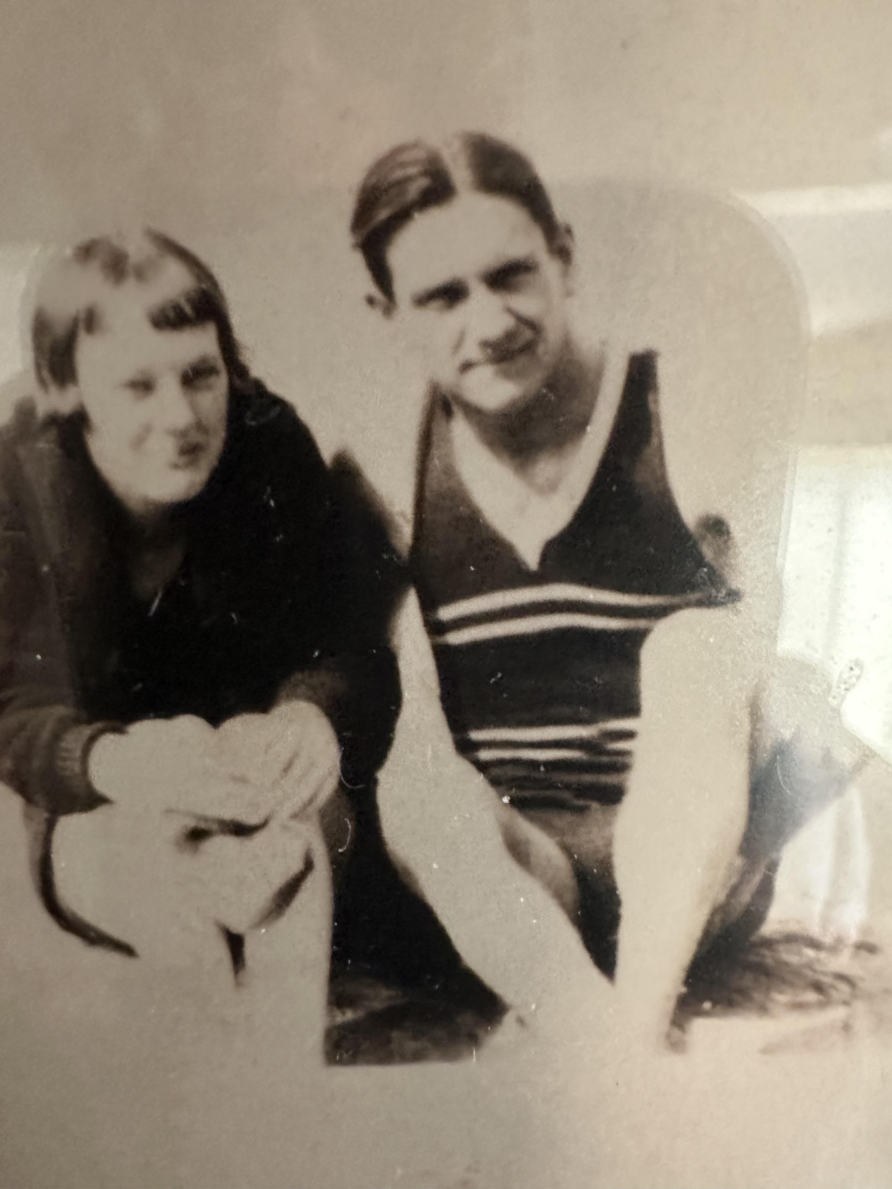 A man and woman sitting on the ground
