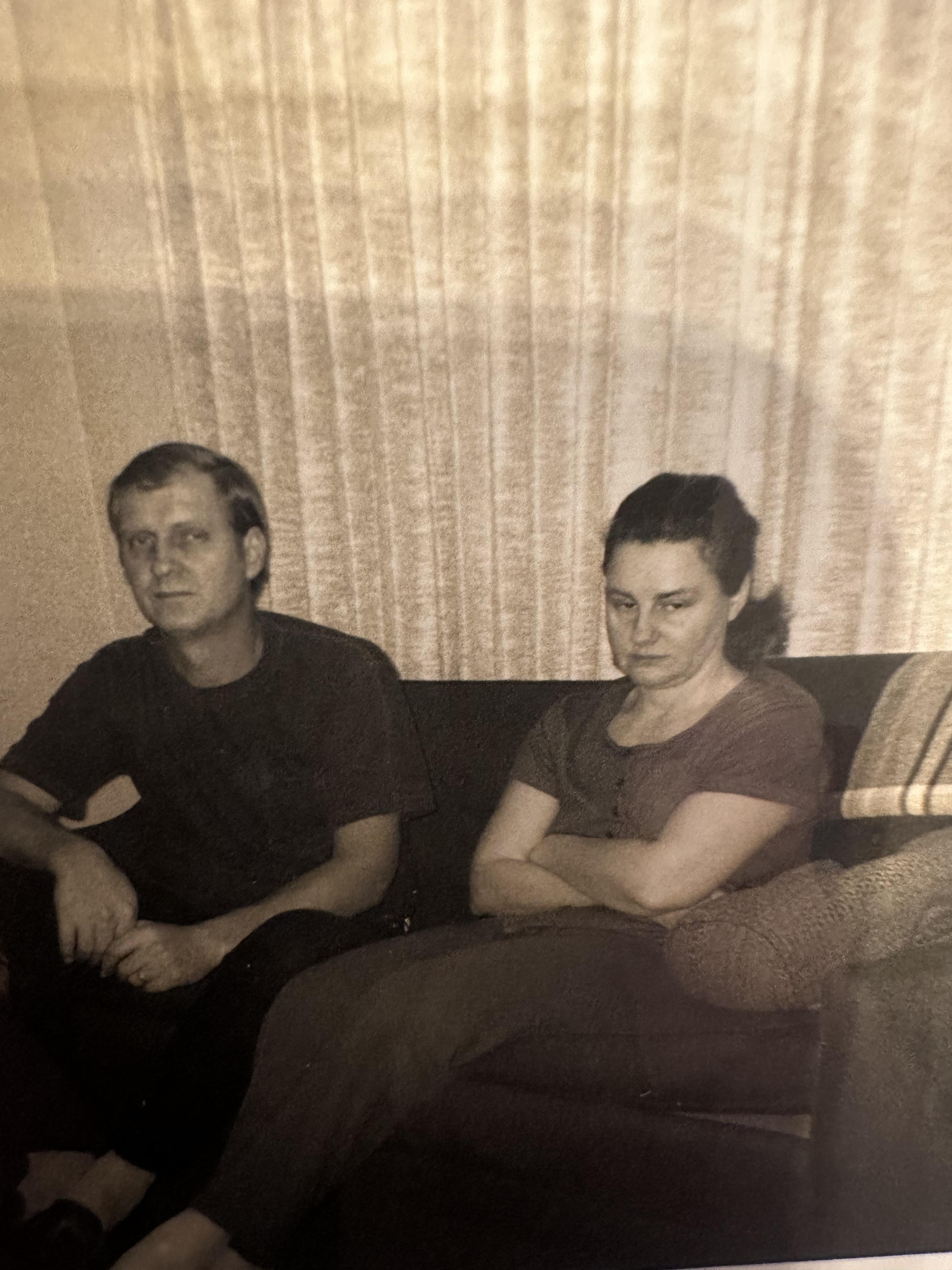 A man and woman sitting on a couch