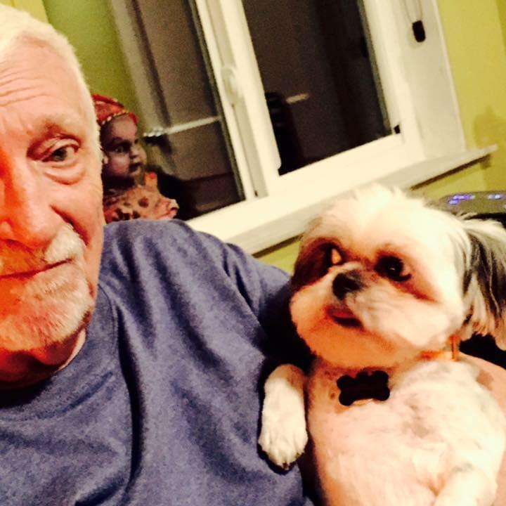 A man holding a dog
