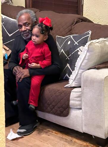 A man and a child sitting on a couch