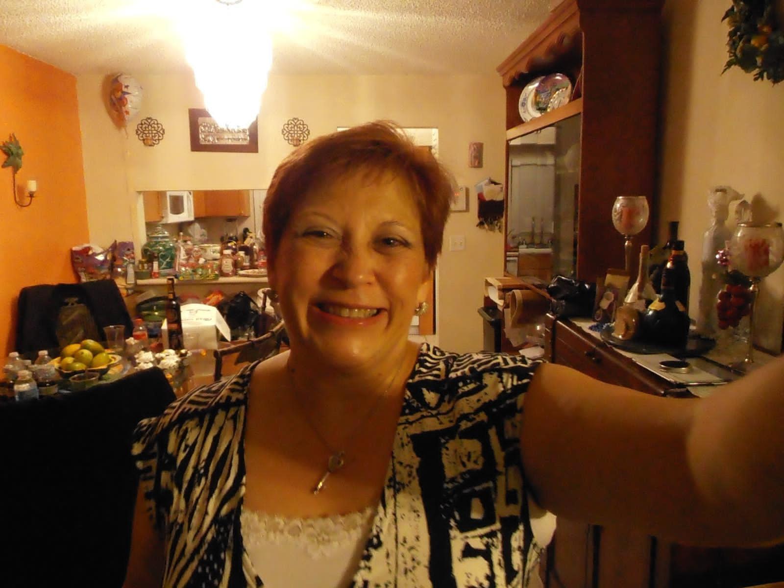 A woman taking a selfie in a kitchen