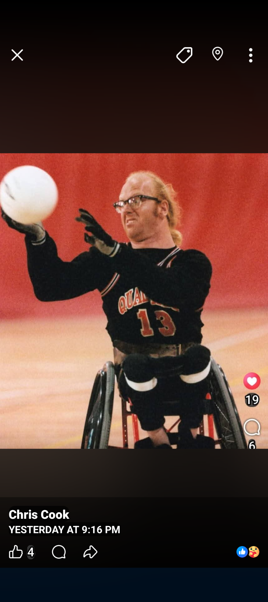 A man in a wheelchair playing with a ball