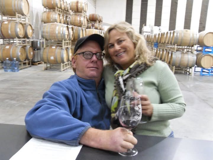 A man and woman holding wine glasses
