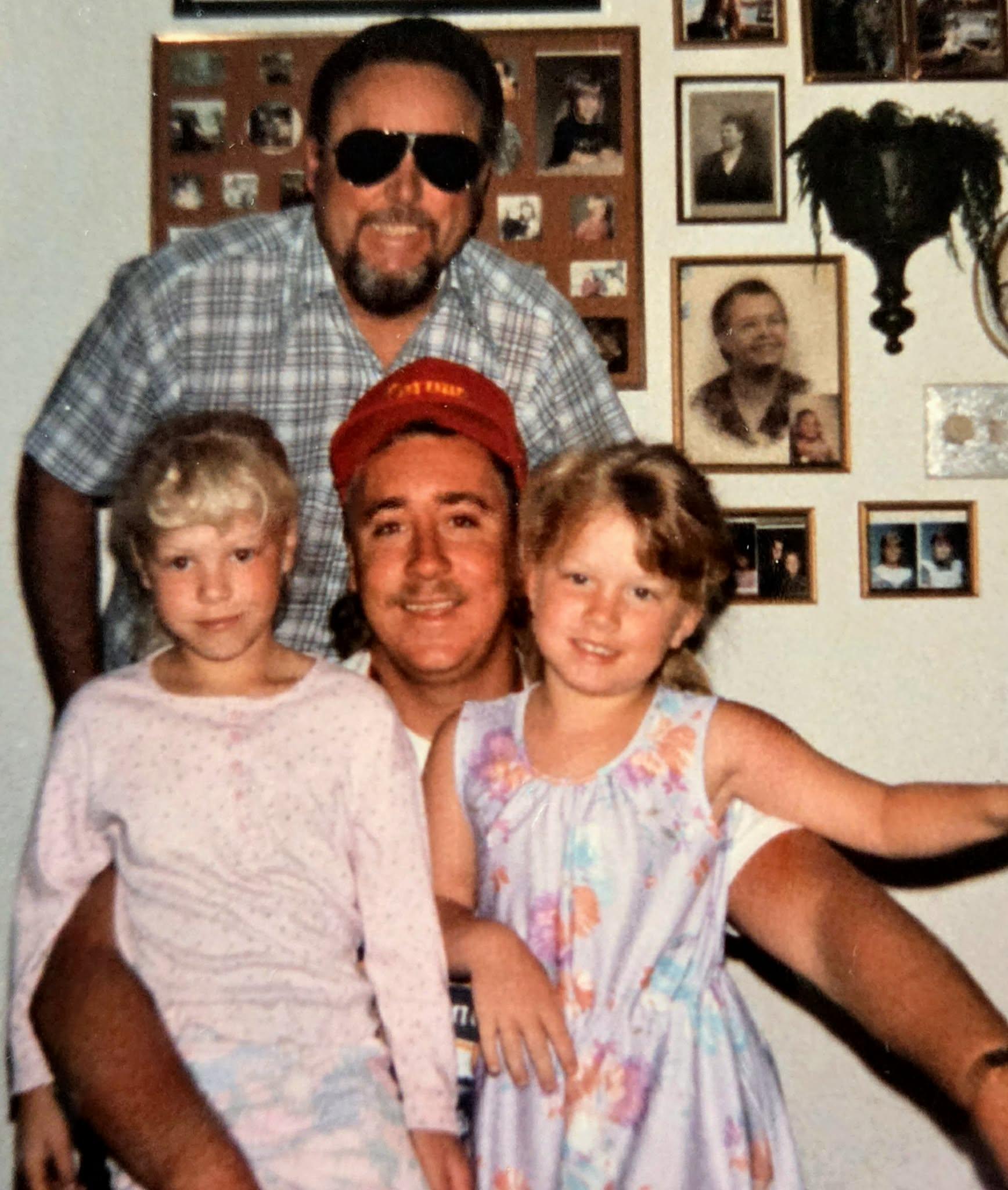 A man and two children posing for a picture
