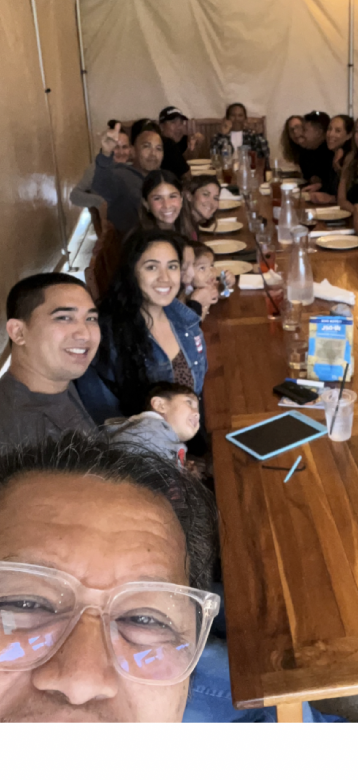 A group of people sitting at a long table