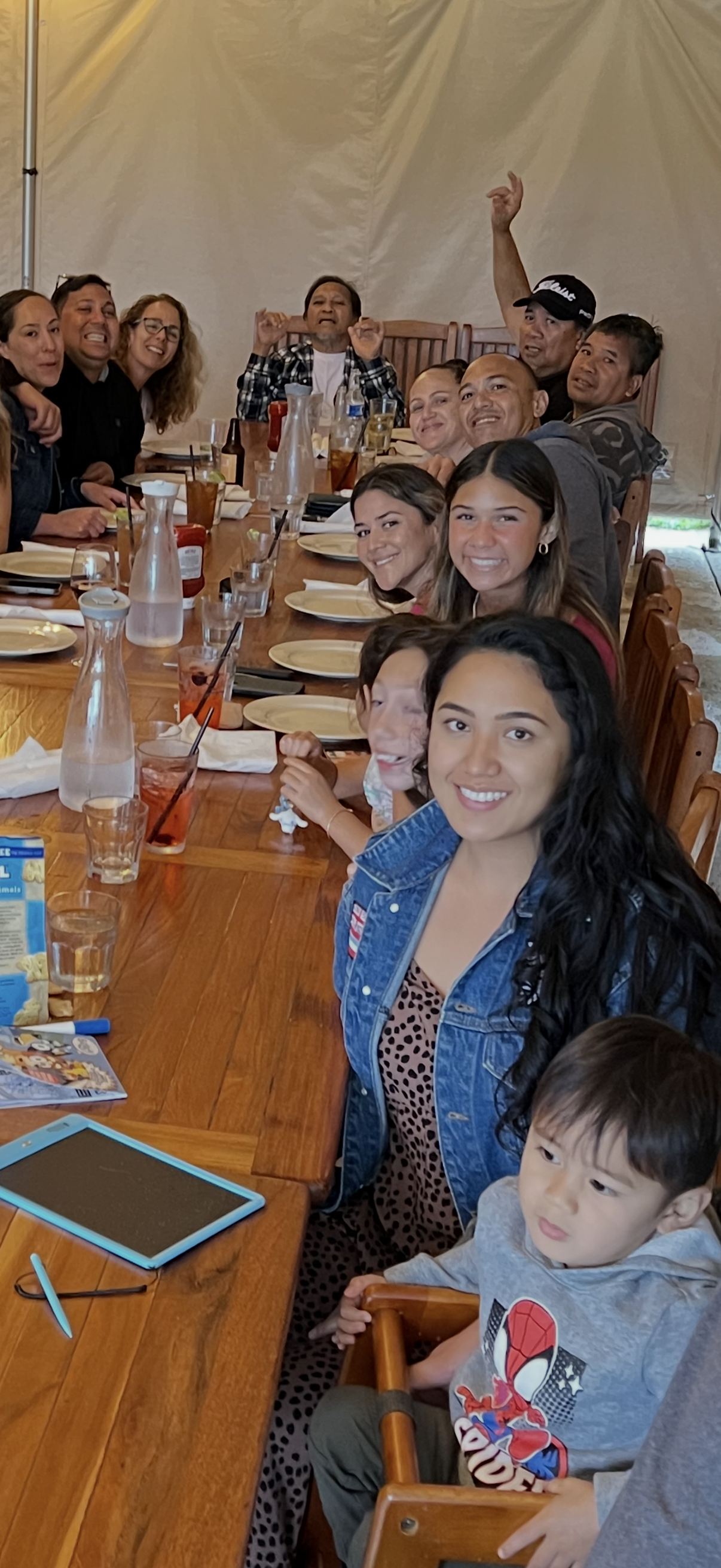 A group of people sitting at a long table