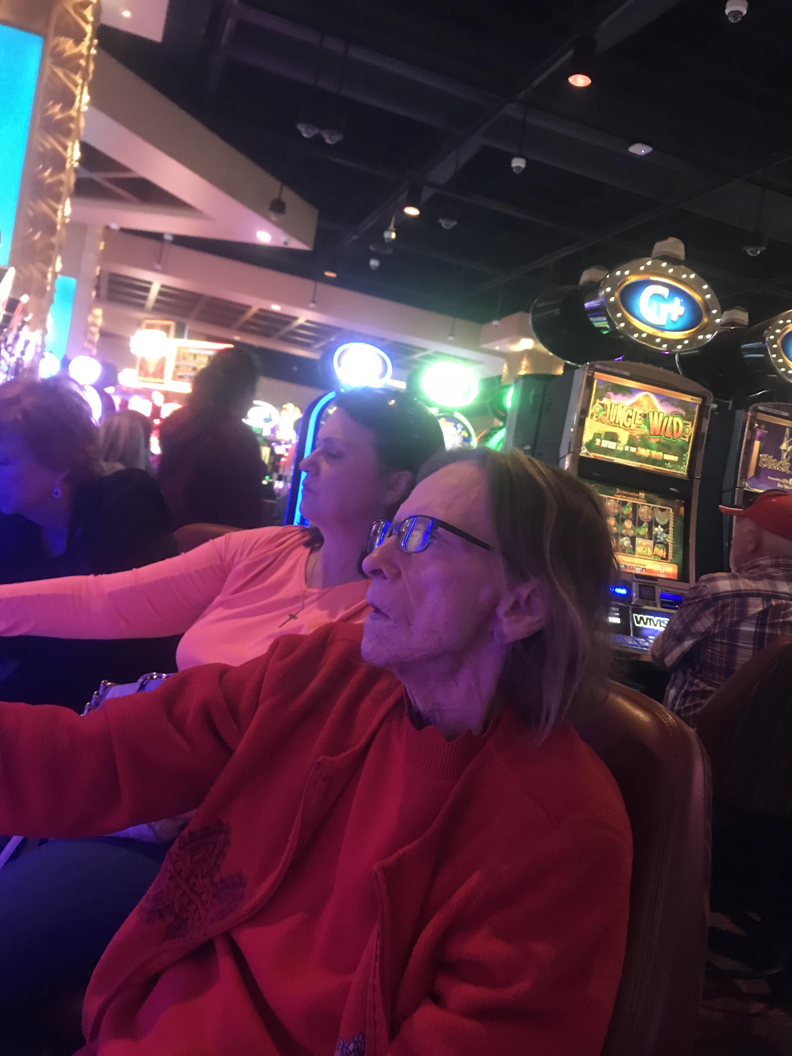 A woman sitting in a chair in a casino