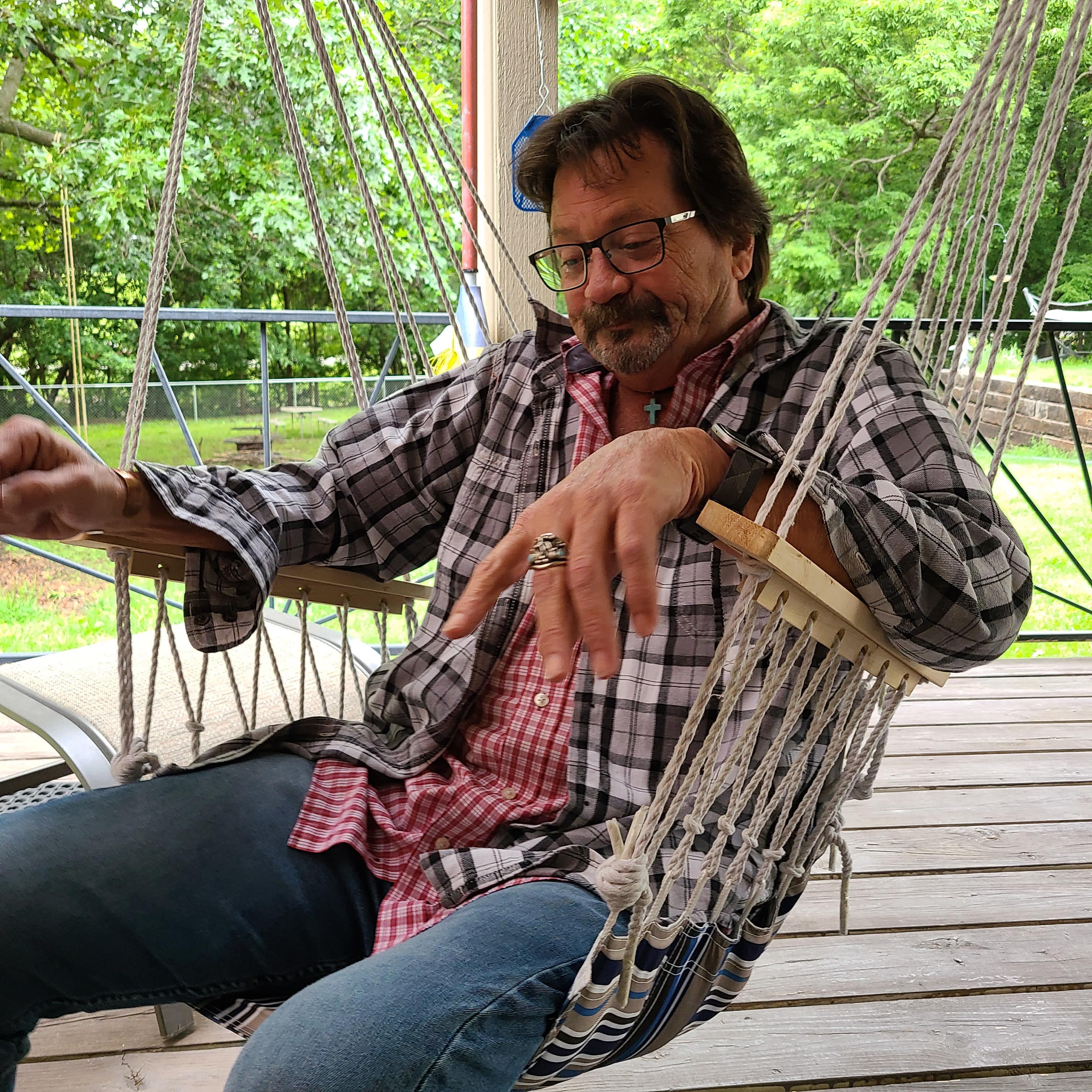 A man sitting in a hammock