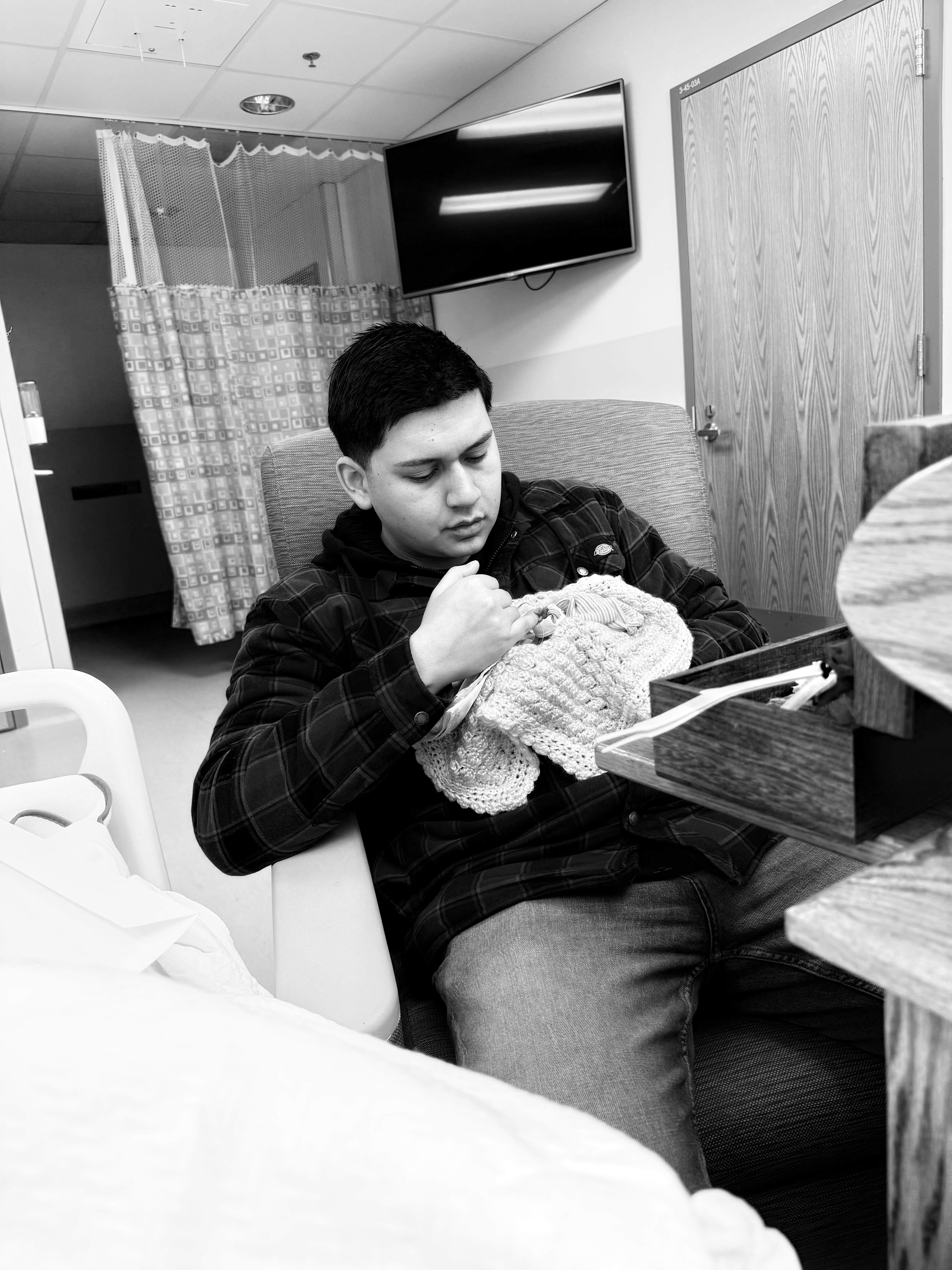 A man knitting a blanket