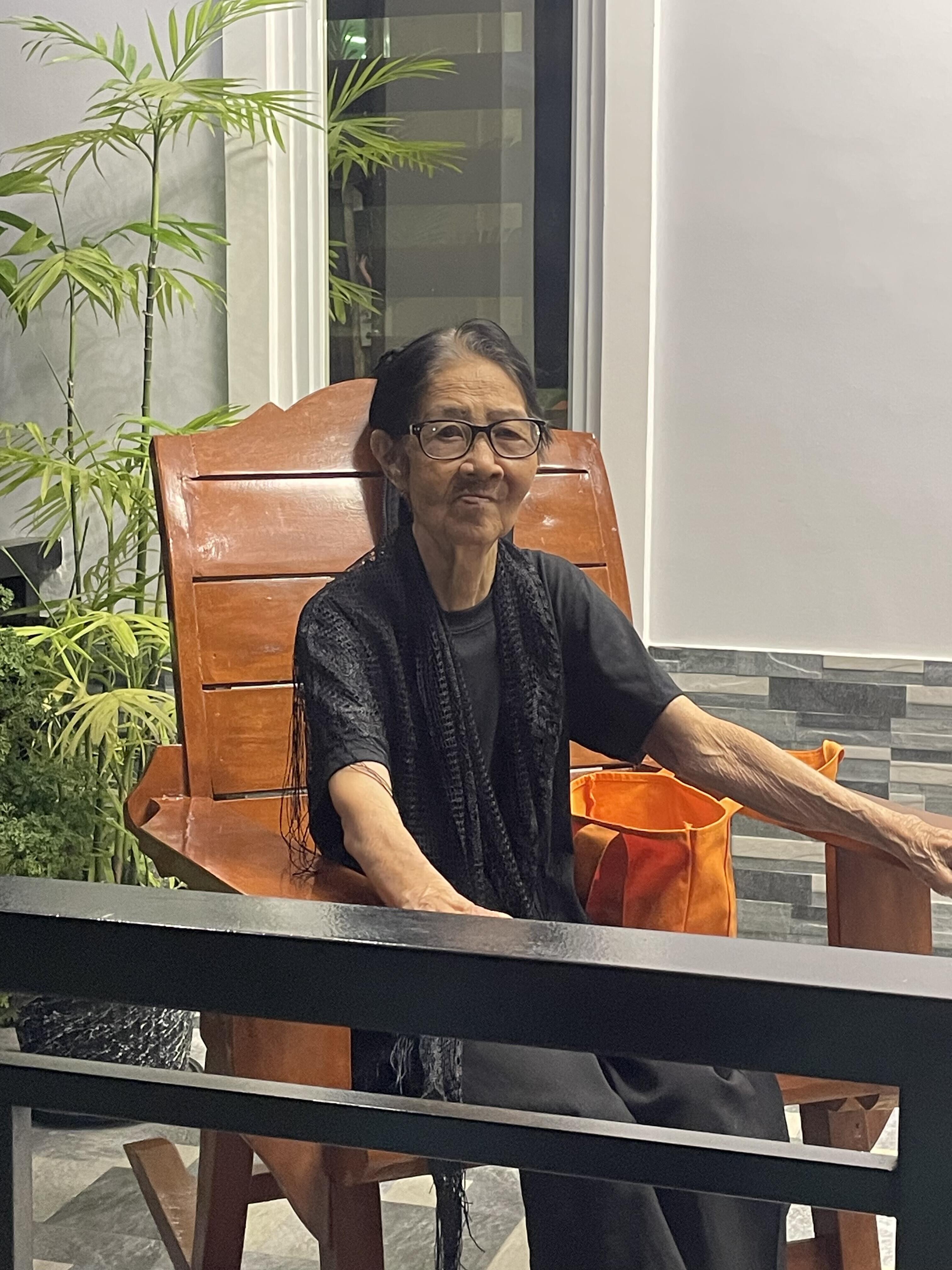 An old woman sitting in a chair