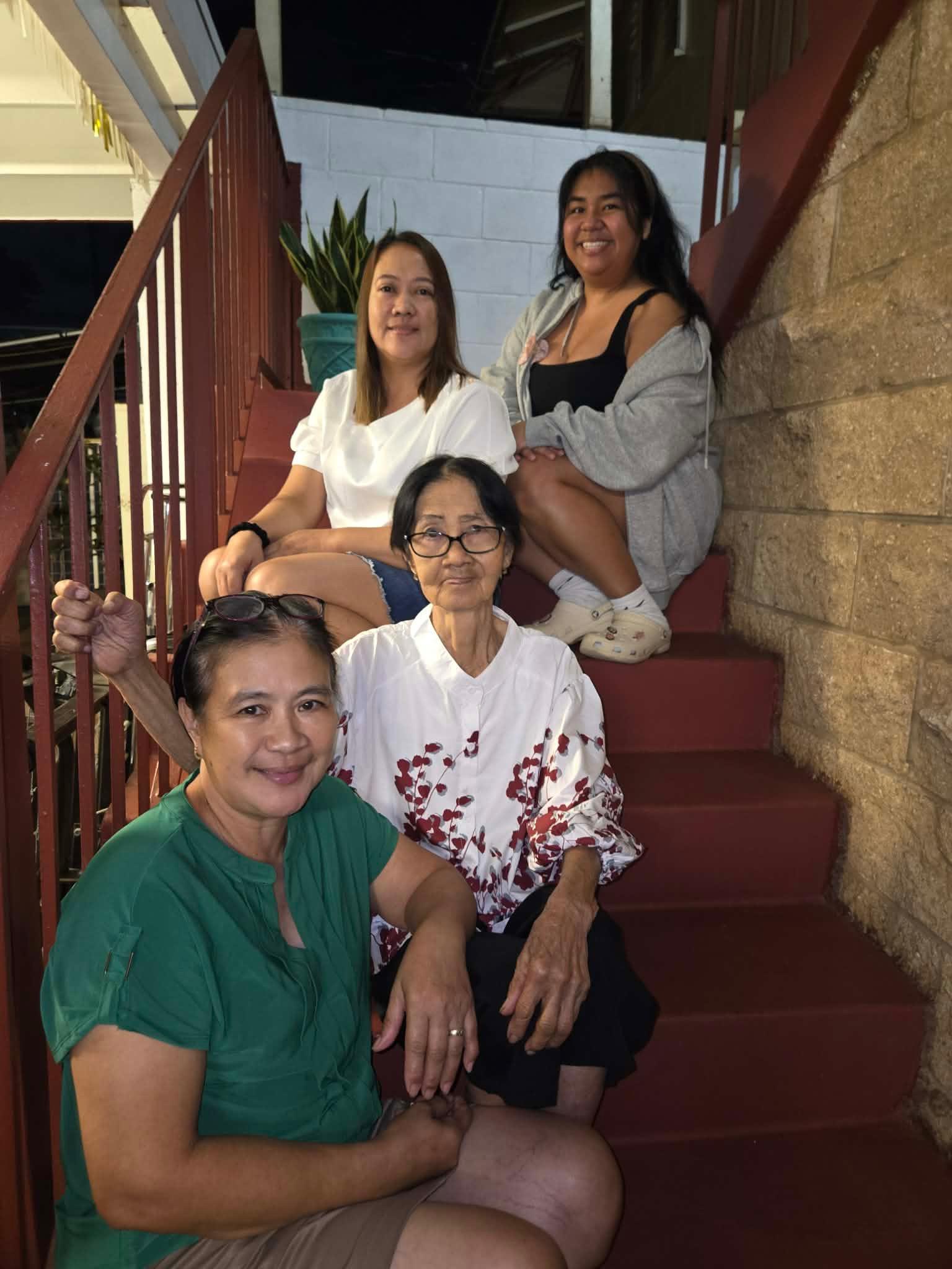 A group of women sitting on stairs