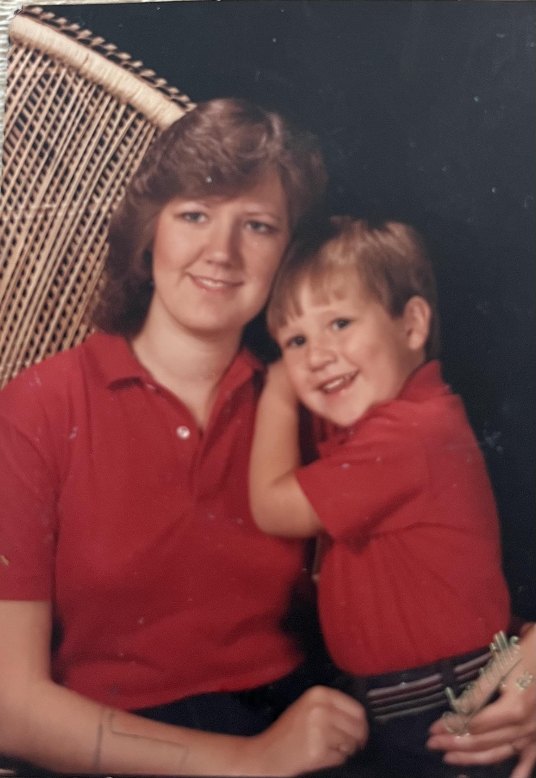 A woman and a boy posing for a picture