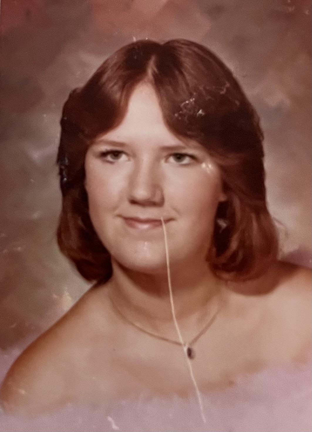 A woman with a string in her mouth