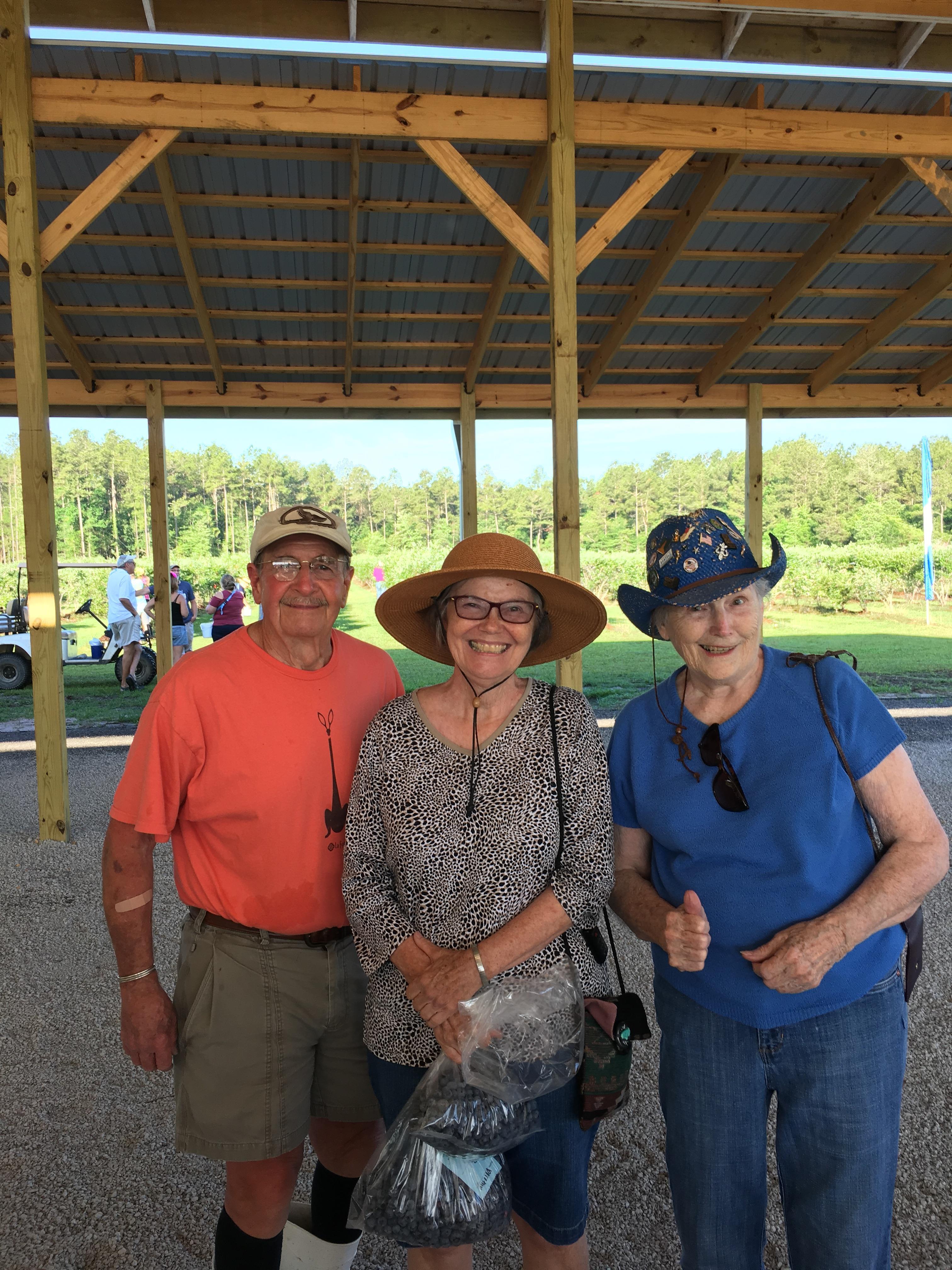A group of people standing under a shelter