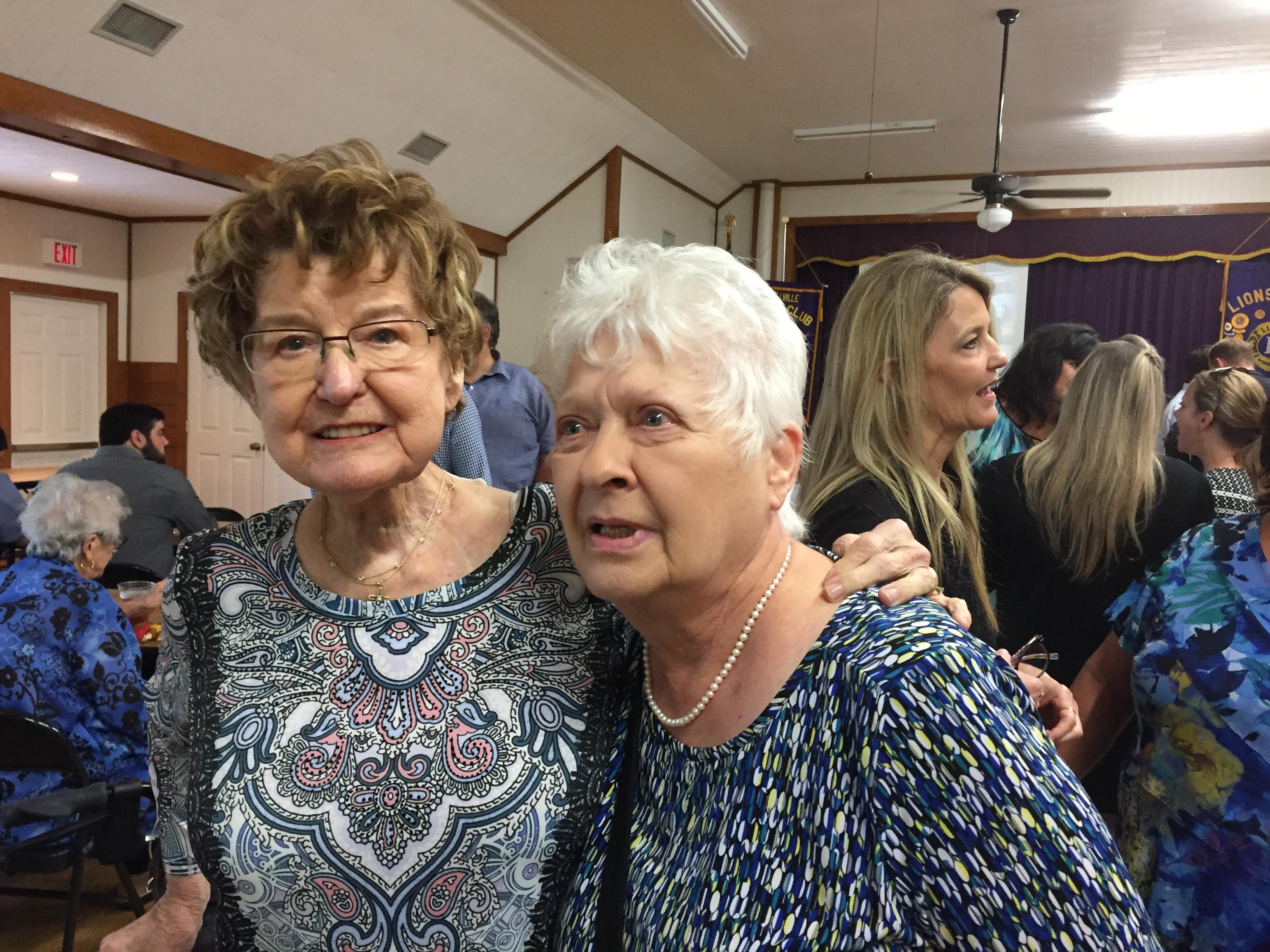 Two women standing together in a room
