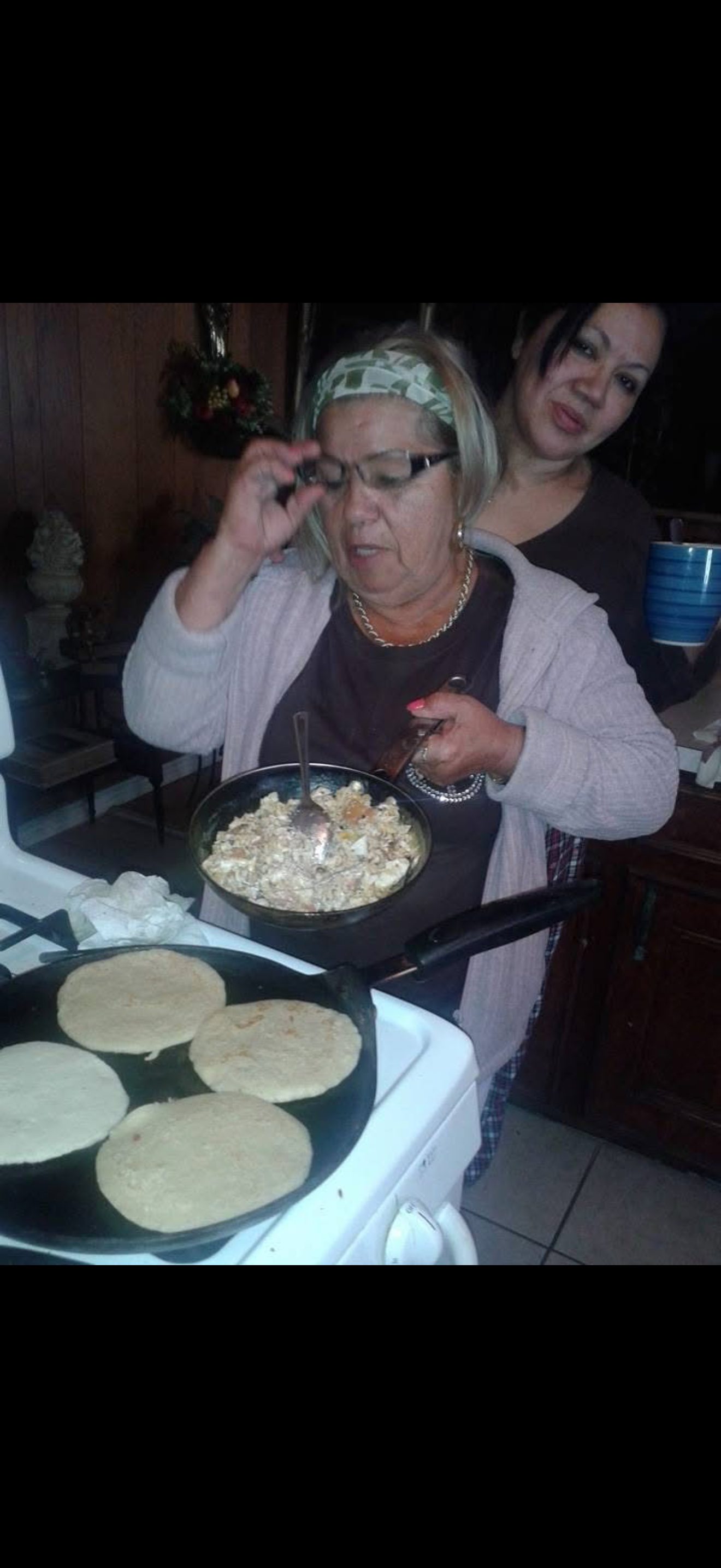 A woman cooking breakfast in a kitchen
