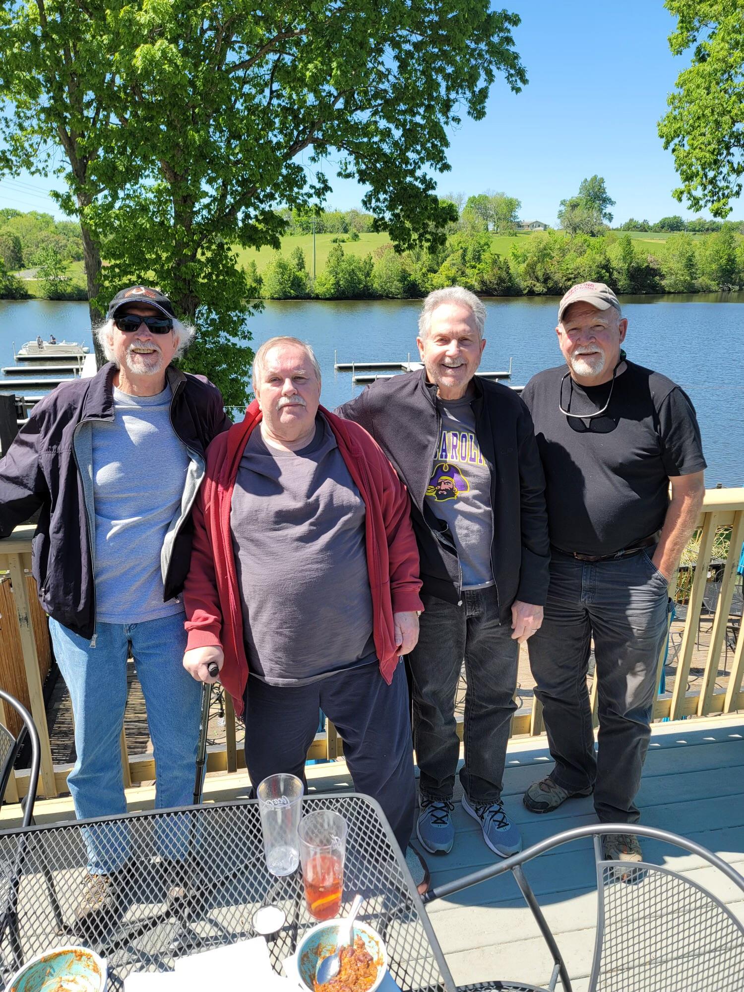 A group of men standing on a deck