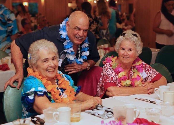 A group of elderly people sitting at a table