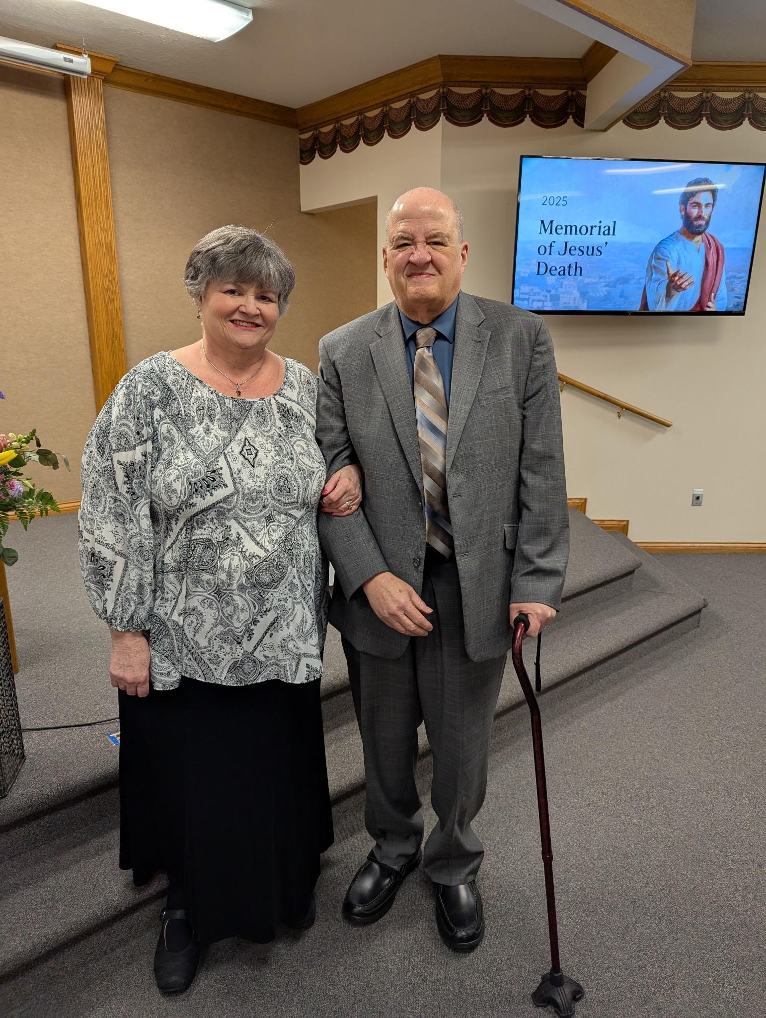 A man and woman standing in front of stairs