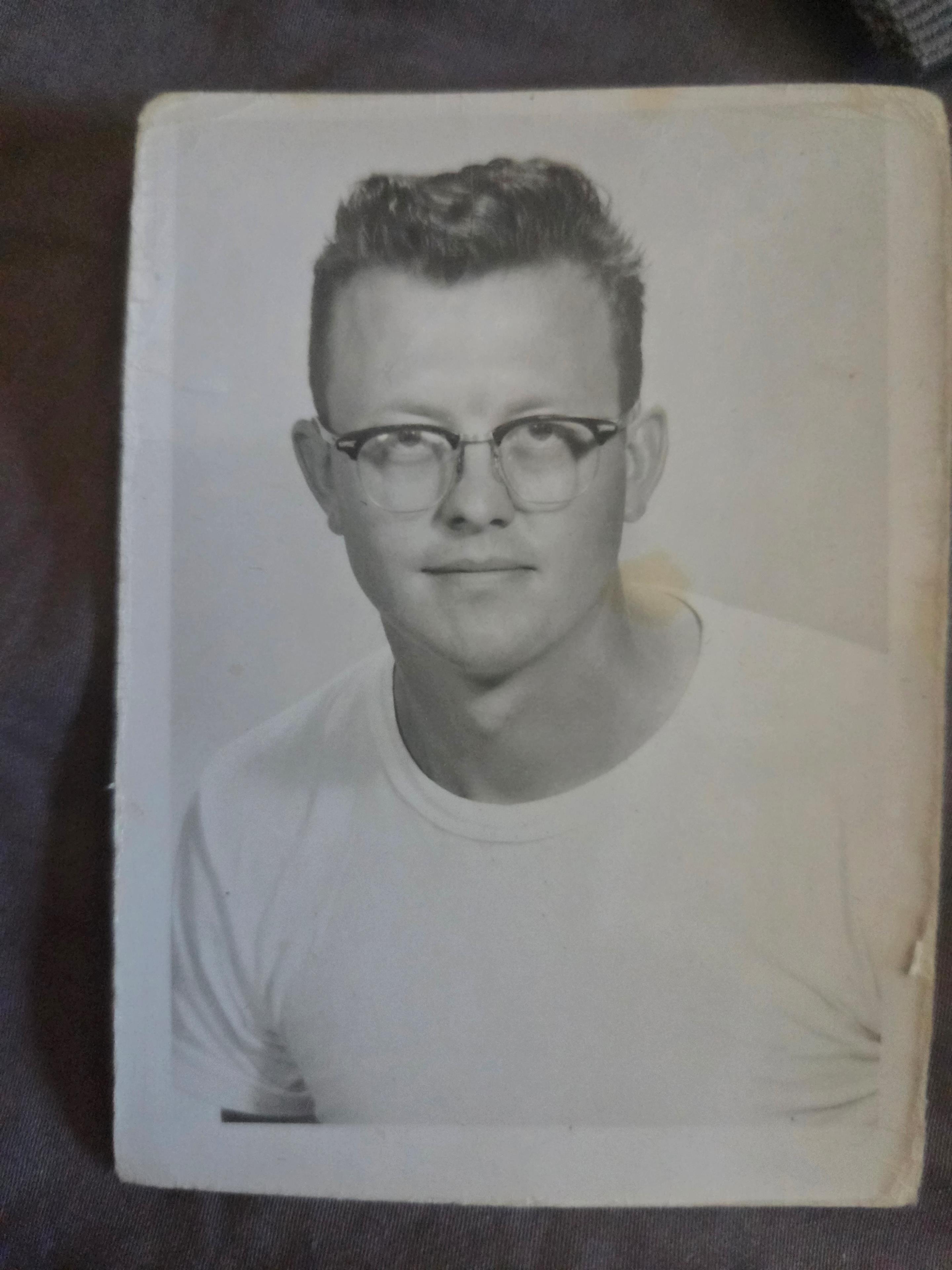 A man wearing glasses and a white shirt