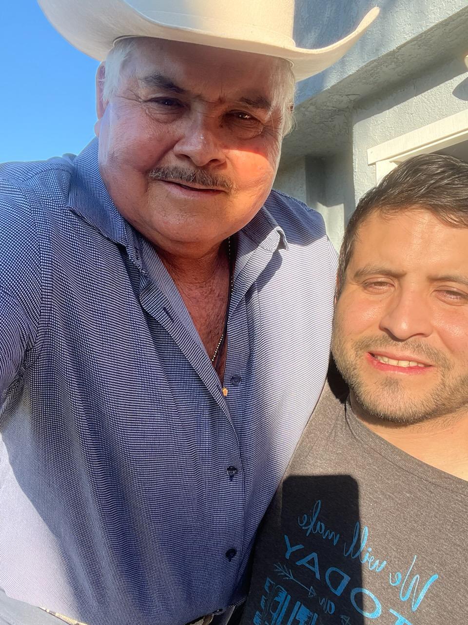 A man taking a selfie with another man