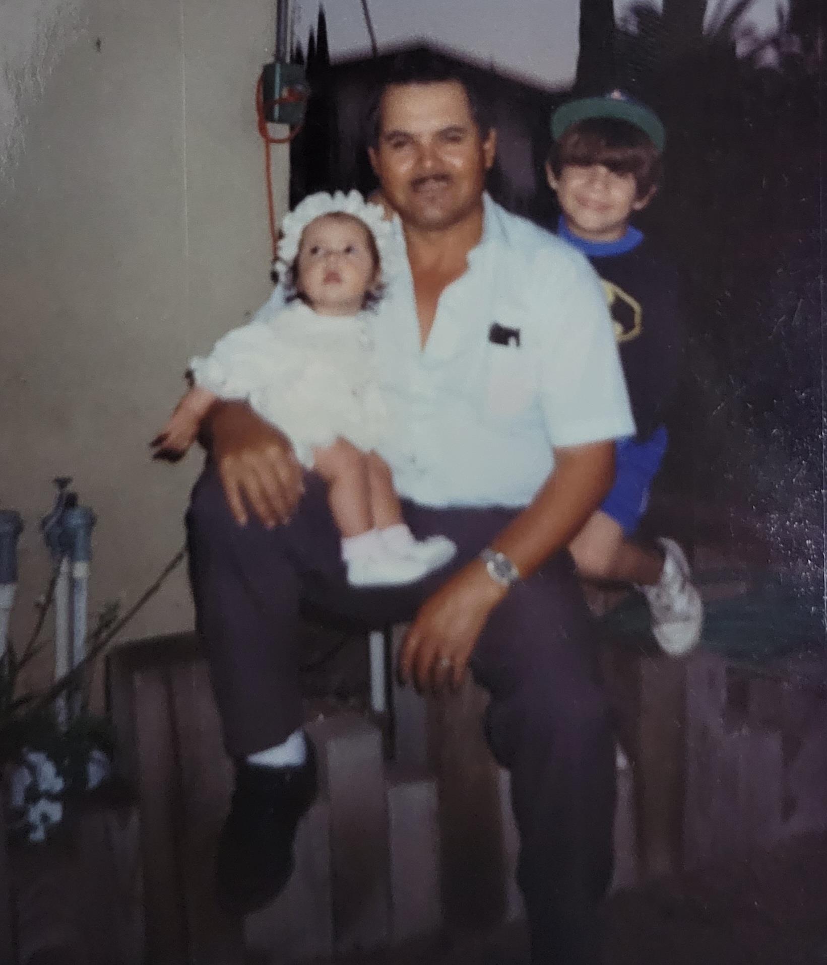 A man holding a baby and a boy