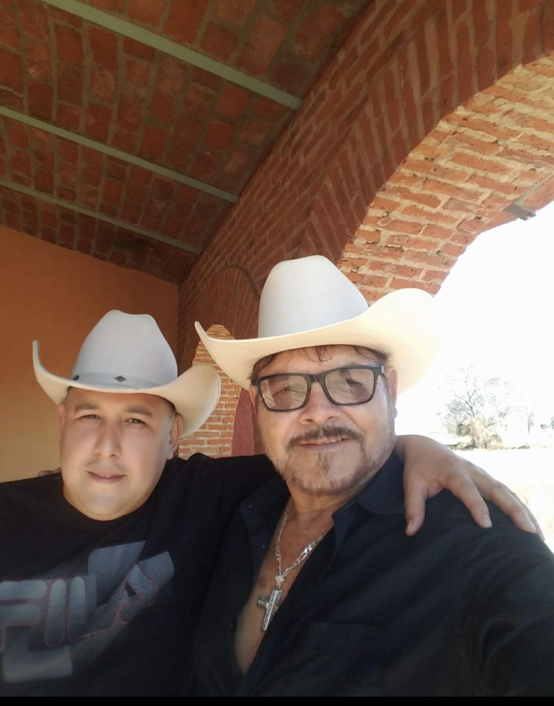 Two men wearing cowboy hats