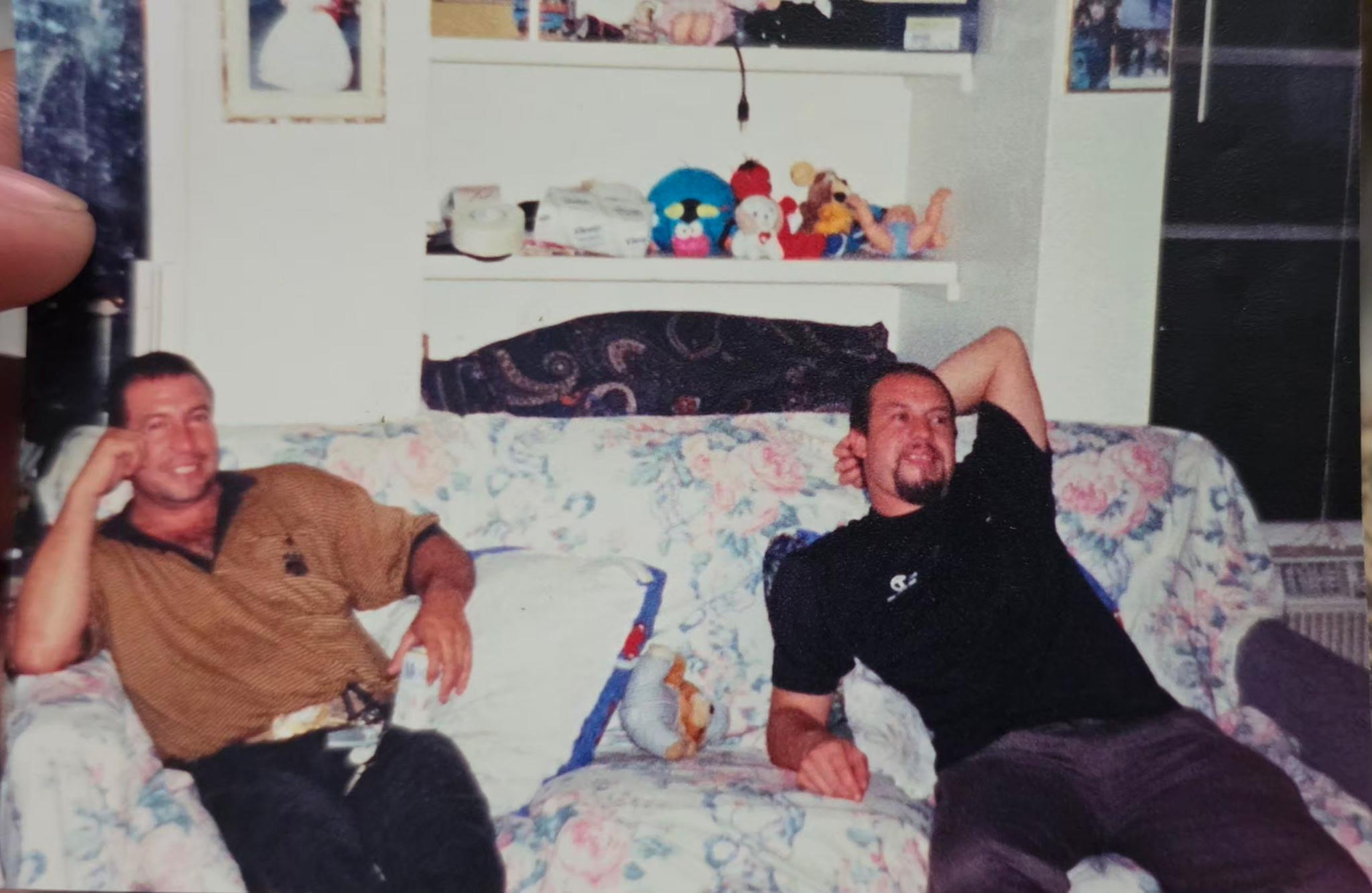 A couple of men sitting on a couch