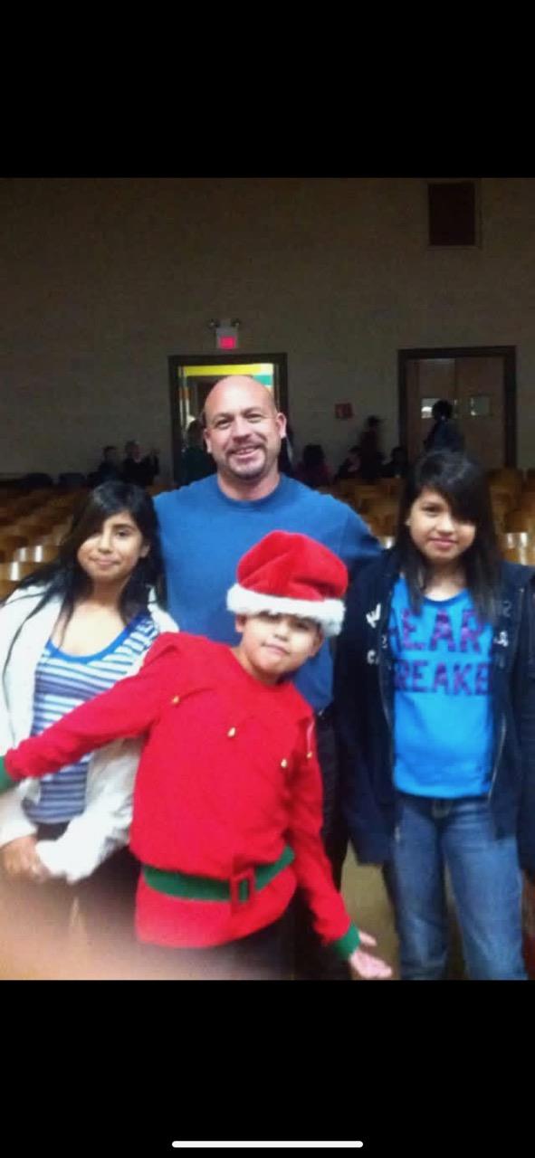 A man and two children posing for a picture